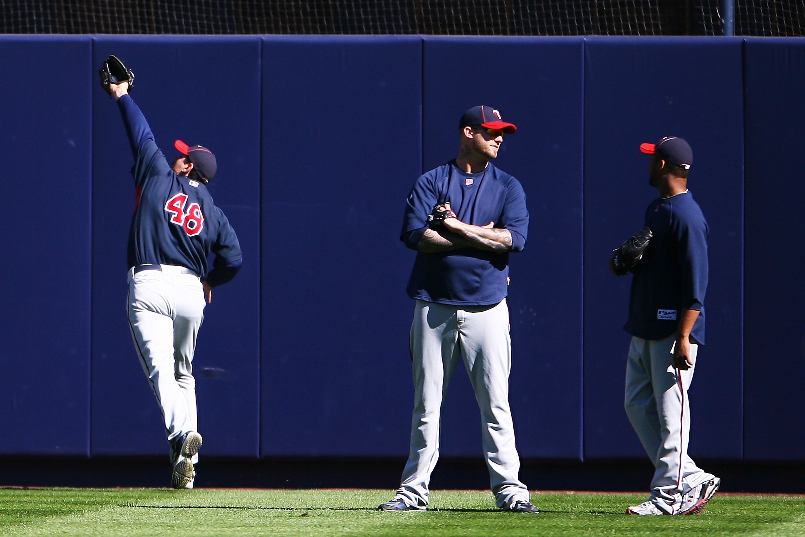 NEW YORK - OCTOBER 08: (L-R) Carl Pavano #48 of the Minnesota Twins fields a ball while Jon Rauch #60 and Francisco Liriano #47 talk during warm ups prior to game three, to take place on October 9, of the America League Division Series against the New Yor NEW YORK - OCTOBER 08: (L-R) Carl Pavano #48 of the Minnesota Twins fields a ball while Jon Rauch #60 and Francisco Liriano #47 talk during warm ups prior to game three, to take place on October 9, of the America League Division Series against the New Yor