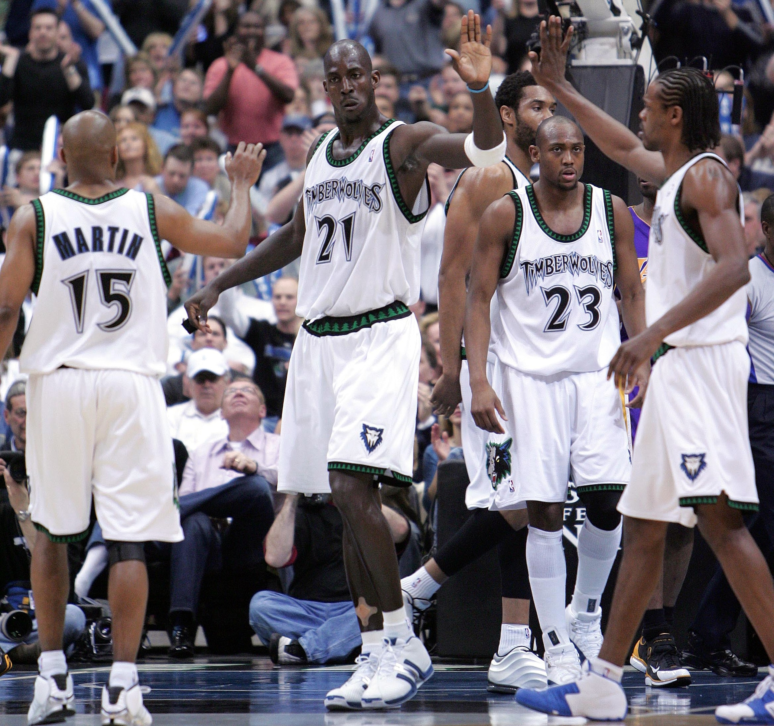 MINNEAPOLIS - MAY 29:  Kevin Garnett #21, Latrell Sprewell #8 and Darrick Martin #15 of the Minnesota Timberwolves celebrate in Game five of the Western Conference Finals against the Los Angeles Lakers during the 2004 NBA Playoffs on May 29, 2004 at Targe