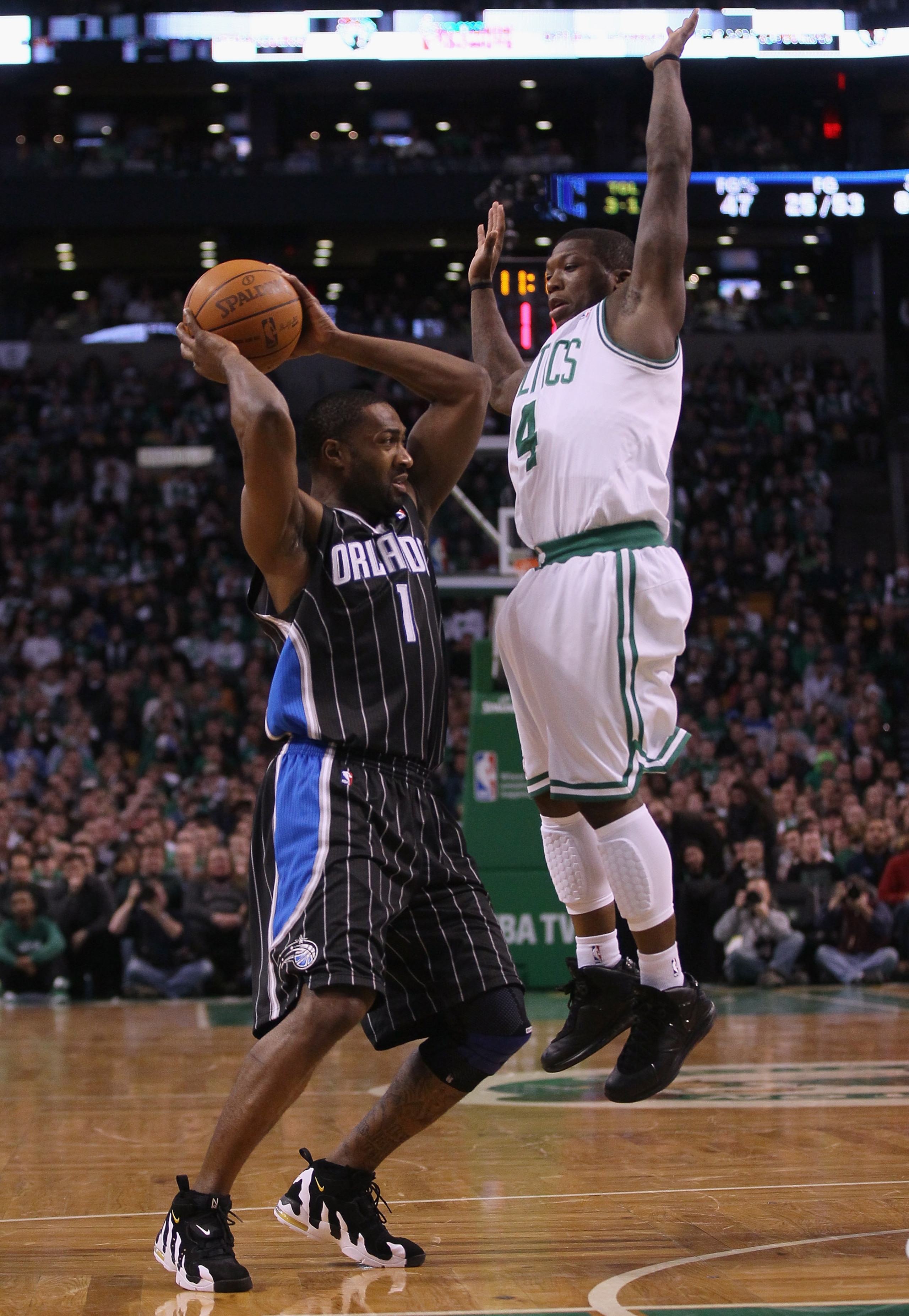 BOSTON, MA - JANUARY 17: Gilbert Arenas #1 of the Orlando Magic tries to pass as Nate Robinson #4 of the Boston Celtics defends on January 17, 2011 at the TD Garden in Boston, Massachusetts. The Celtics defeated the Magic 109-106. NOTE TO USER: User ex BOSTON, MA - JANUARY 17: Gilbert Arenas #1 of the Orlando Magic tries to pass as Nate Robinson #4 of the Boston Celtics defends on January 17, 2011 at the TD Garden in Boston, Massachusetts. The Celtics defeated the Magic 109-106. NOTE TO USER: User ex