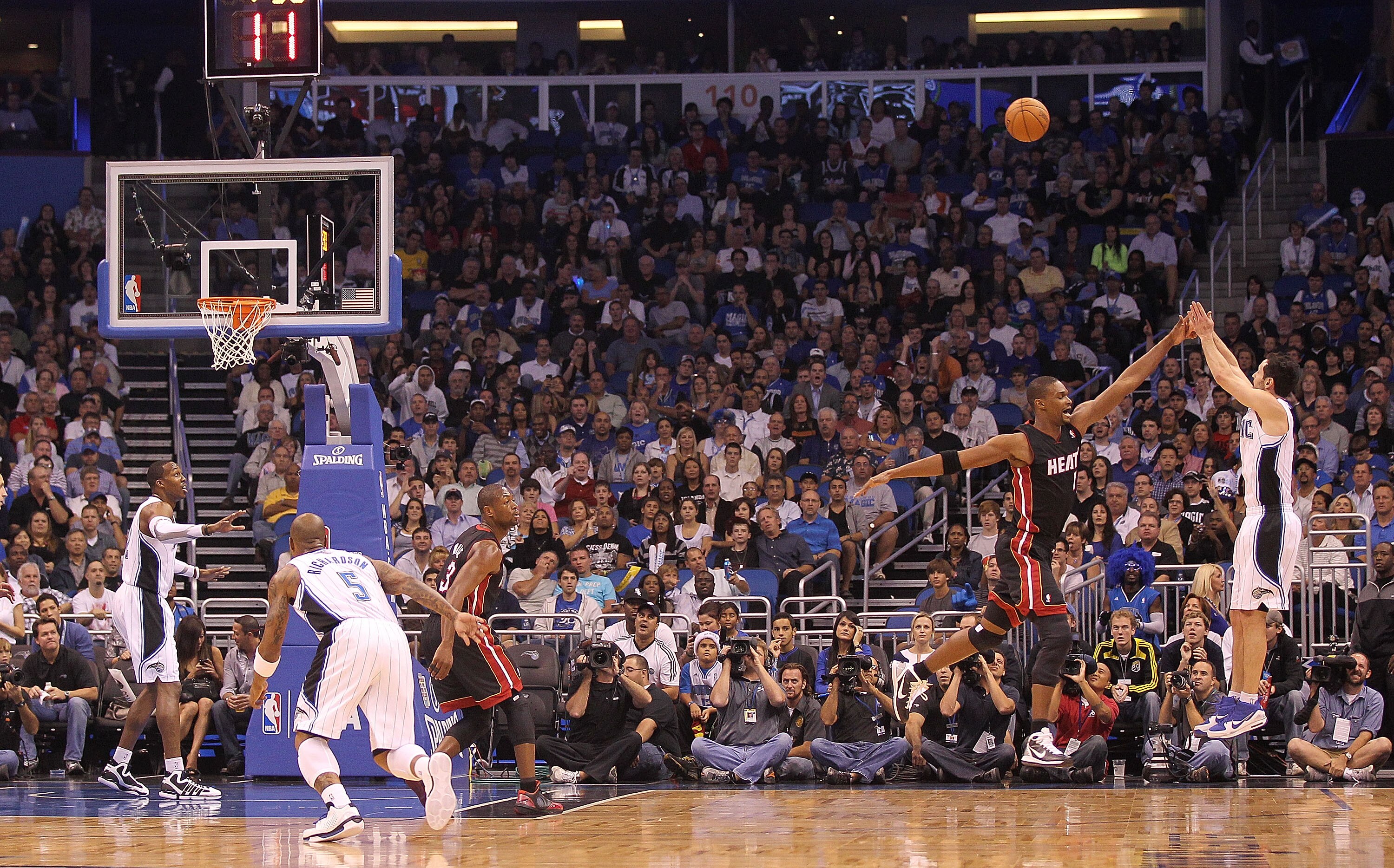 ORLANDO, FL - NOVEMBER 24:  J.J. Reddick #7 of the Orlando Magic shoots over Chris Bosh #1 of the Miami Heat during a game at Amway Arena on November 24, 2010 in Orlando, Florida. NOTE TO USER: User expressly acknowledges and agrees that, by downloading a