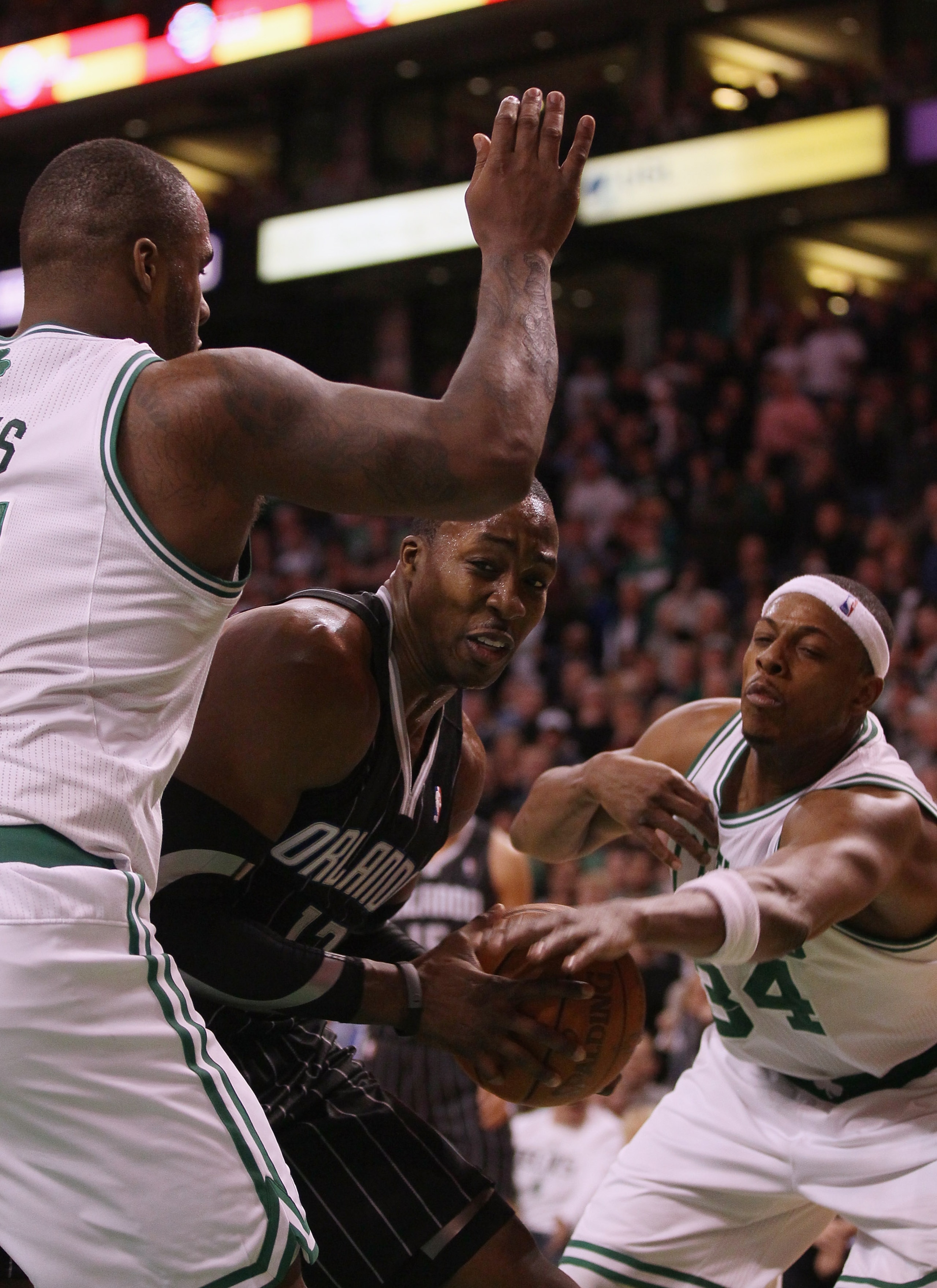BOSTON, MA - JANUARY 17: Dwight Howard #12 of the Orlando Magic tries to get past Glen Davis #11 and Paul Pierce #34 of the Boston Celtics on January 17, 2011 at the TD Garden in Boston, Massachusetts. The Celtics defeated the Magic 109-106. NOTE TO U BOSTON, MA - JANUARY 17: Dwight Howard #12 of the Orlando Magic tries to get past Glen Davis #11 and Paul Pierce #34 of the Boston Celtics on January 17, 2011 at the TD Garden in Boston, Massachusetts. The Celtics defeated the Magic 109-106. NOTE TO U