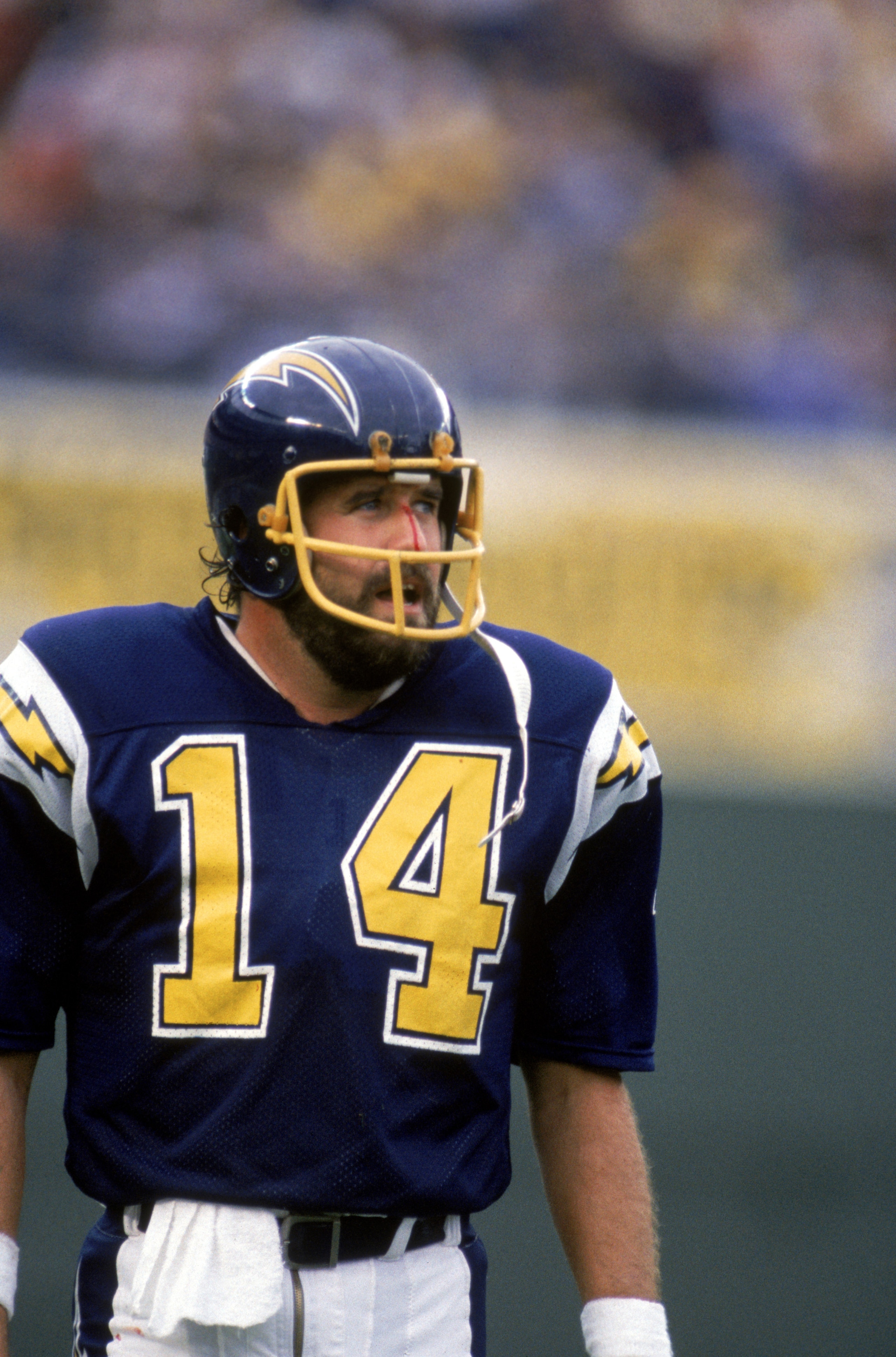 SAN DIEGO - NOVEMBER 10:  Quarterback Dan Fouts #14 of the San Diego Chargers looks on as blood runs down the bridge of his nose during a game against the Los Angeles Raiders at Jack Murphy Stadium on November 10, 1985 in San Diego, California.  The Charg