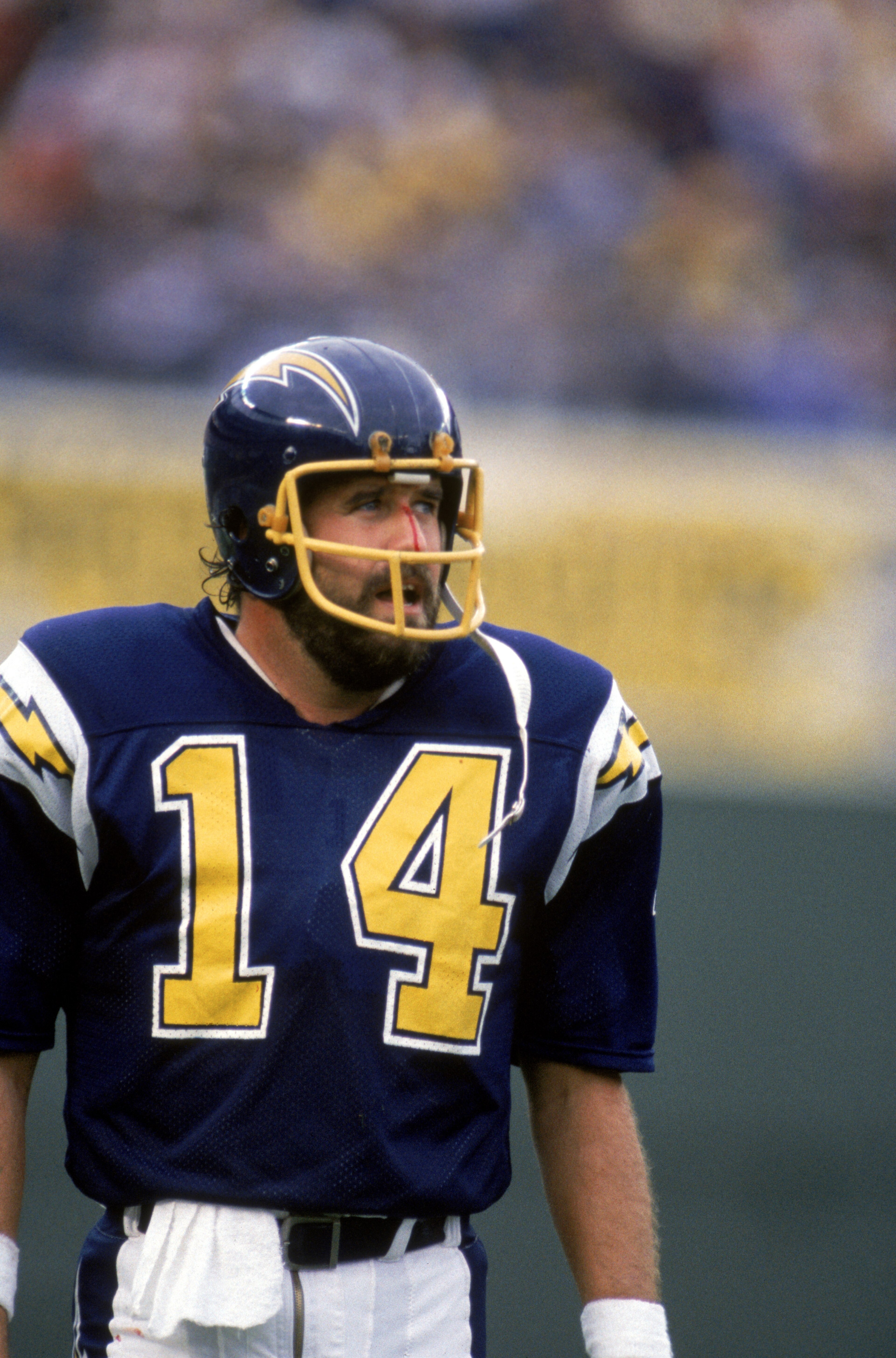 SAN DIEGO - NOVEMBER 10:  Quarterback Dan Fouts #14 of the San Diego Chargers looks on as blood runs down the bridge of his nose during a game against the Los Angeles Raiders at Jack Murphy Stadium on November 10, 1985 in San Diego, California.  The Charg