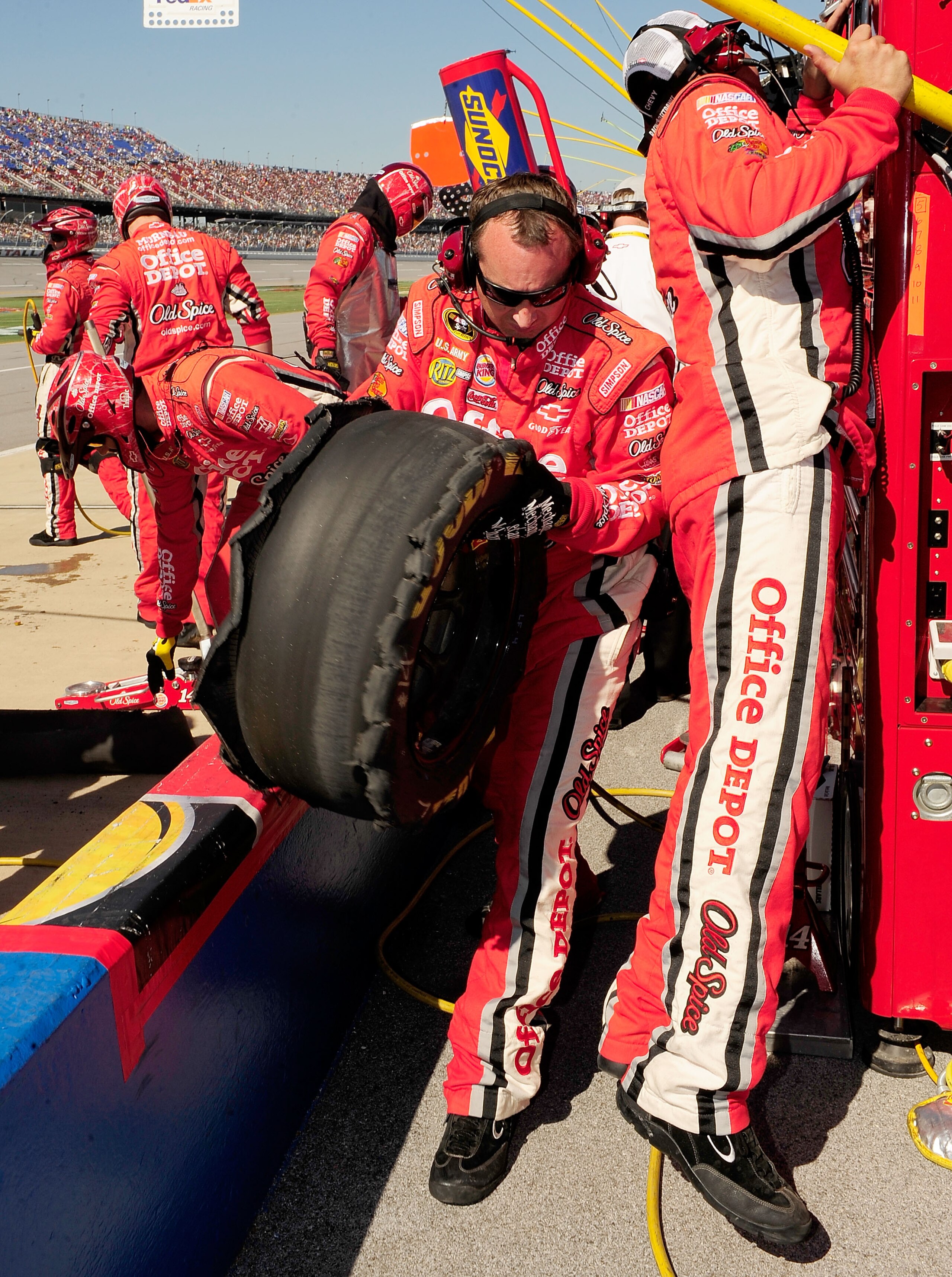 TALLADEGA, AL - OCTOBER 31:  Crew members look over a blown tire from the #14 Old Spice/Office Depot Chevrolet, driven by Tony Stewart, in the pit box during the NASCAR Sprint Cup Series AMP Energy Juice 500 at Talladega Superspeedway on October 31, 2010
