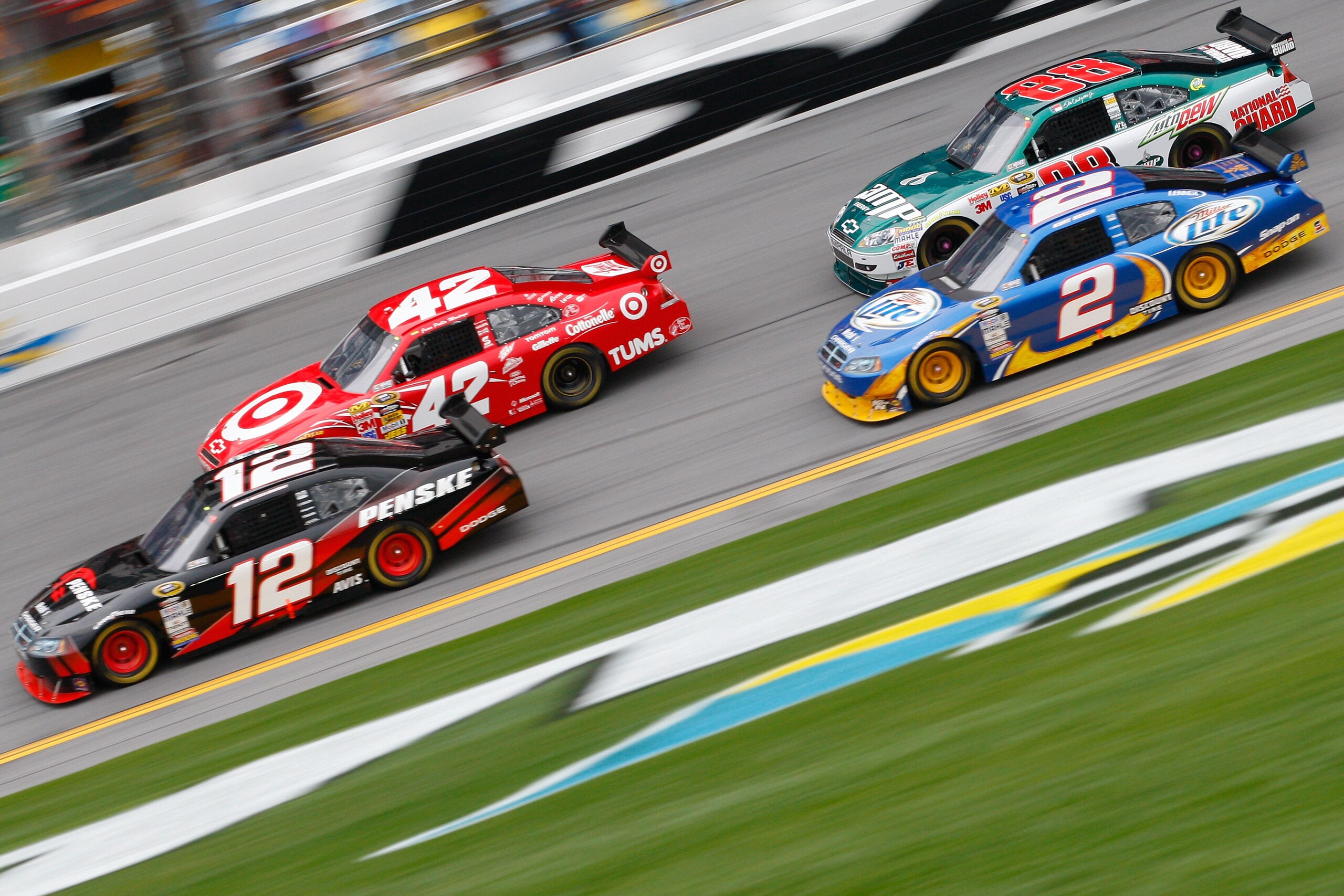 DAYTONA BEACH, FL - FEBRUARY 11:  Brad Keselowski, driver of the #12 Penske Dodge, races infront of Juan Pablo Montoya, driver of the #42 Target Chevrolet, Kurt Busch, driver of the #2 Miller Lite Dodge, and Dale Earnhardt Jr., driver of the #88 AMP Energ
