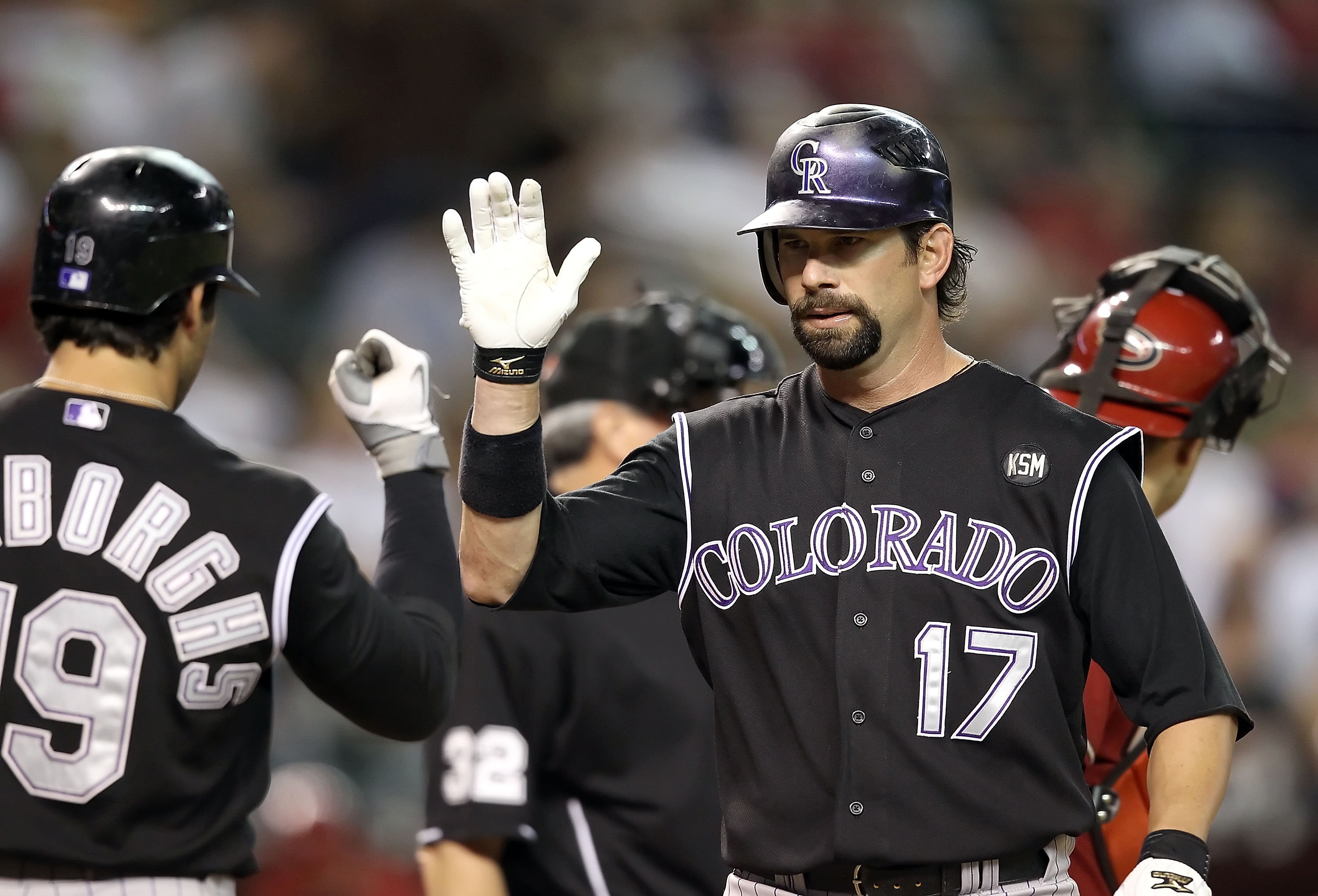 PHOENIX - SEPTEMBER 22:  Todd Helton #17 of the Colorado Rockies high fives teammate Ryan Spilborghs #16 after Helton hit a solo home run against the Arizona Diamondbacks during the first inning of the Major League Baseball game at Chase Field on Septembe