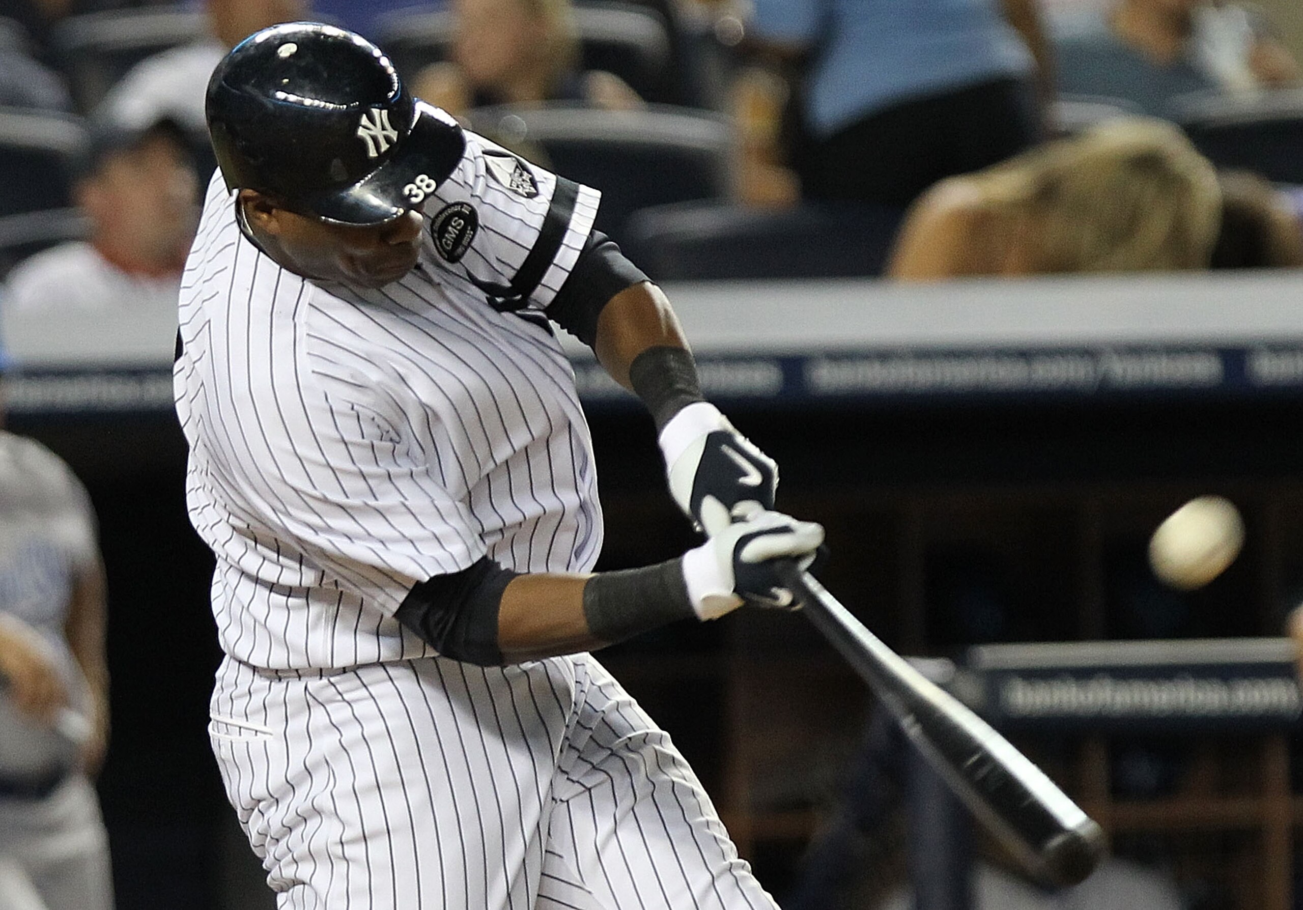 NEW YORK - JULY 22: Marcus Thames #38 of the New York Yankees hits a RBI sacrifice fly to score Jorge Posada #20 against the Kansas City Royals at Yankee Stadium on July 22, 2010 in the Bronx borough of New York City.  (Photo by Nick Laham/Getty Images)