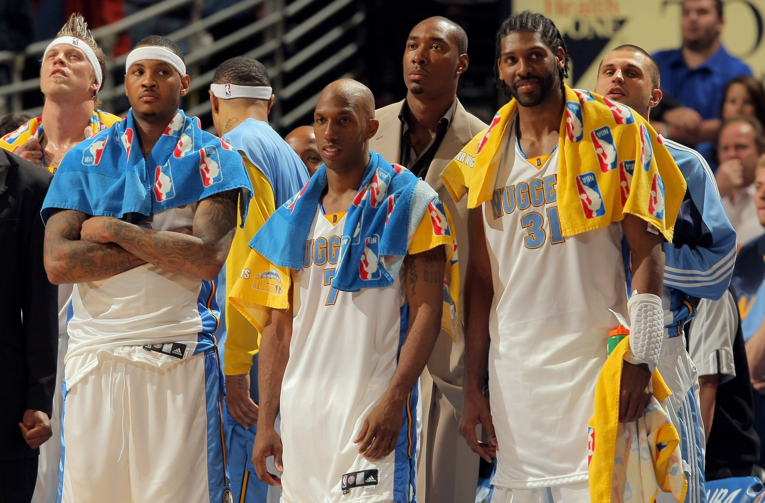 DENVER - APRIL 29:  Starters Carmelo Anthony #15, Chauncey Billups #7 and Nene #31 of the Denver Nuggets watch the final minutes against the New Orleans Hornets from the bench in Game Five of the Western Conference Quarterfinals during the 2009 NBA Playof