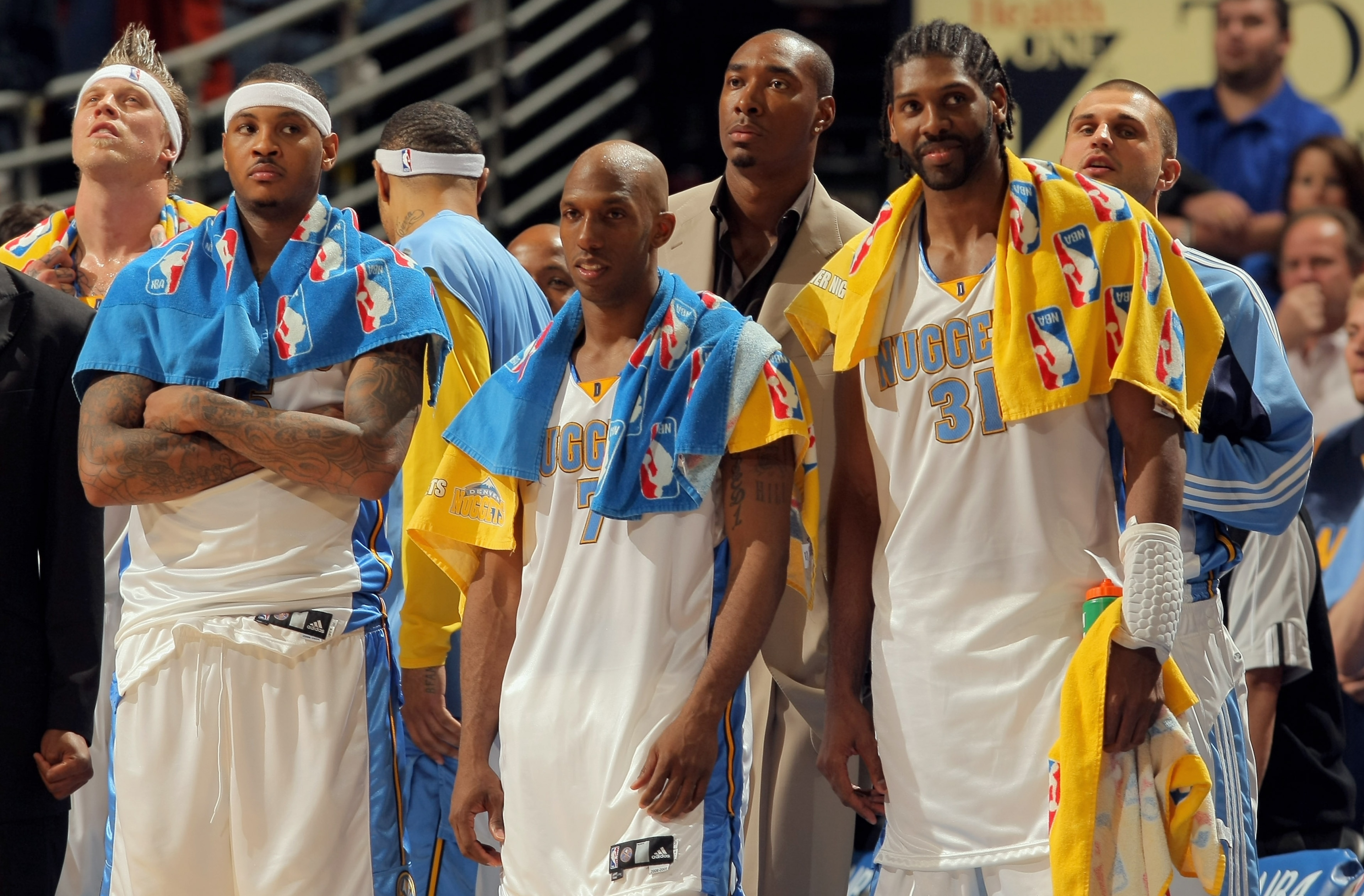 DENVER - APRIL 29:  Starters Carmelo Anthony #15, Chauncey Billups #7 and Nene #31 of the Denver Nuggets watch the final minutes against the New Orleans Hornets from the bench in Game Five of the Western Conference Quarterfinals during the 2009 NBA Playof