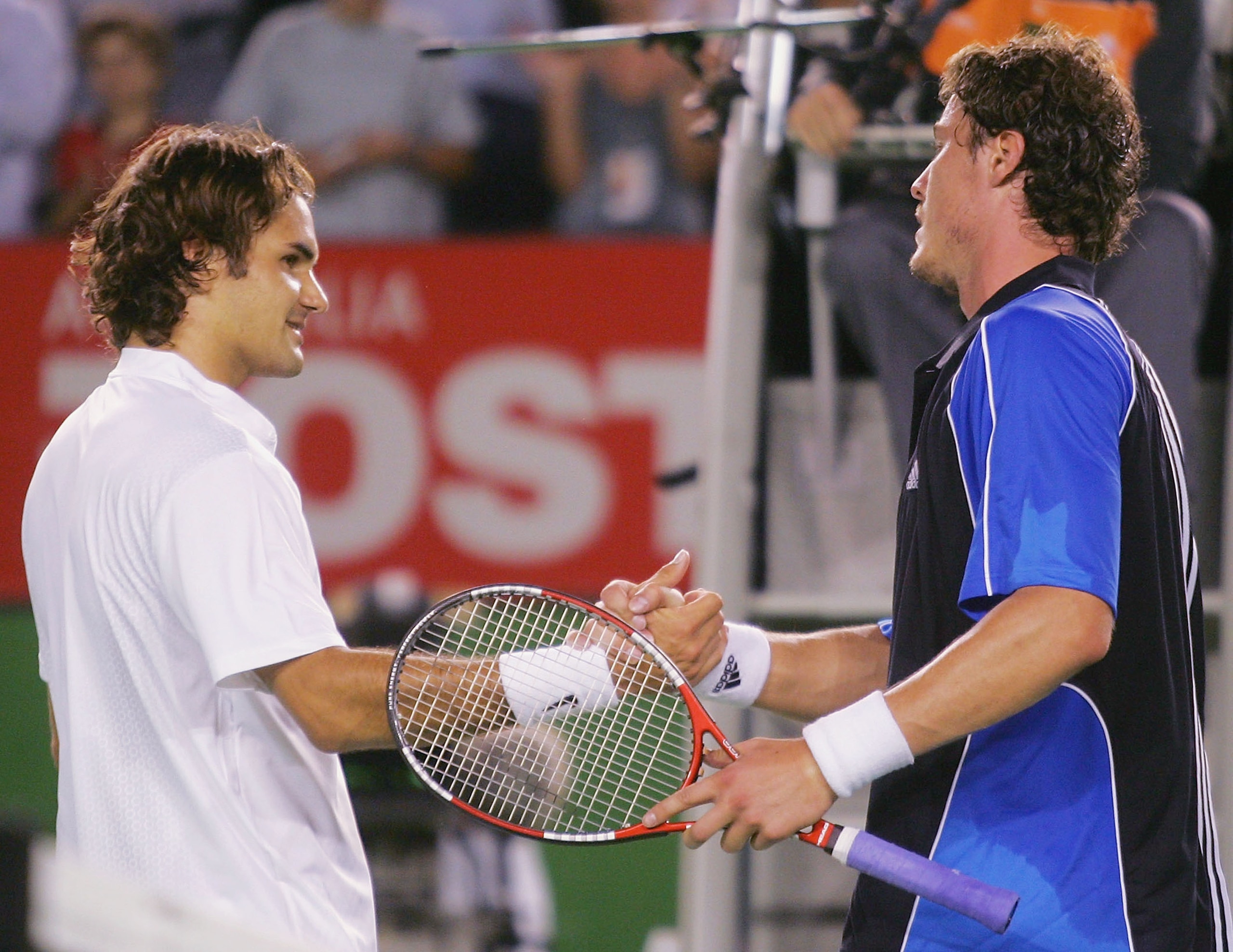 MELBOURNE, AUSTRALIA - JANUARY 27: Marat Safin of Russia (R) shakes the hand of Roger Federer of Switzerland after defeating him during day eleven of the Australian Open Grand Slam, at Melbourne Park January 27, 2005 in Melbourne, Australia. (Photo by Sea