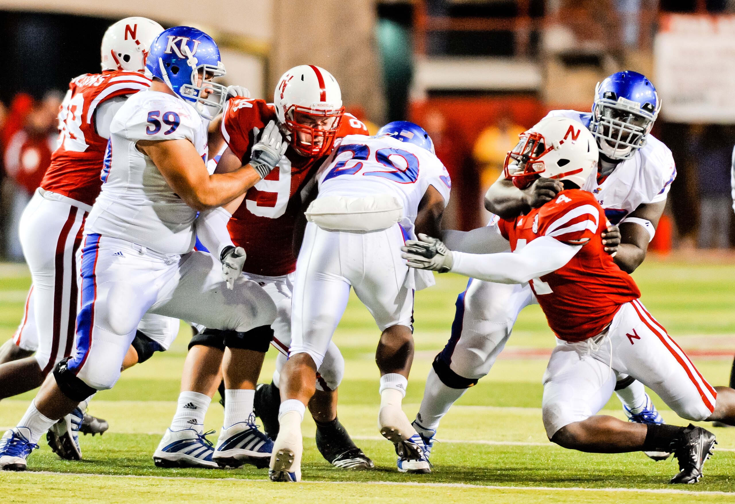 LINCOLN, NE - NOVEMBER 13: James Sims #29 of the Kansas Jayhawks leans for extra yards against the Nebraska Cornhusker defense during their game at Memorial Stadium on November 13, 2010 in Lincoln, Nebraska. Nebraska Defeated Kansas 20-3. (Photo by Eric F