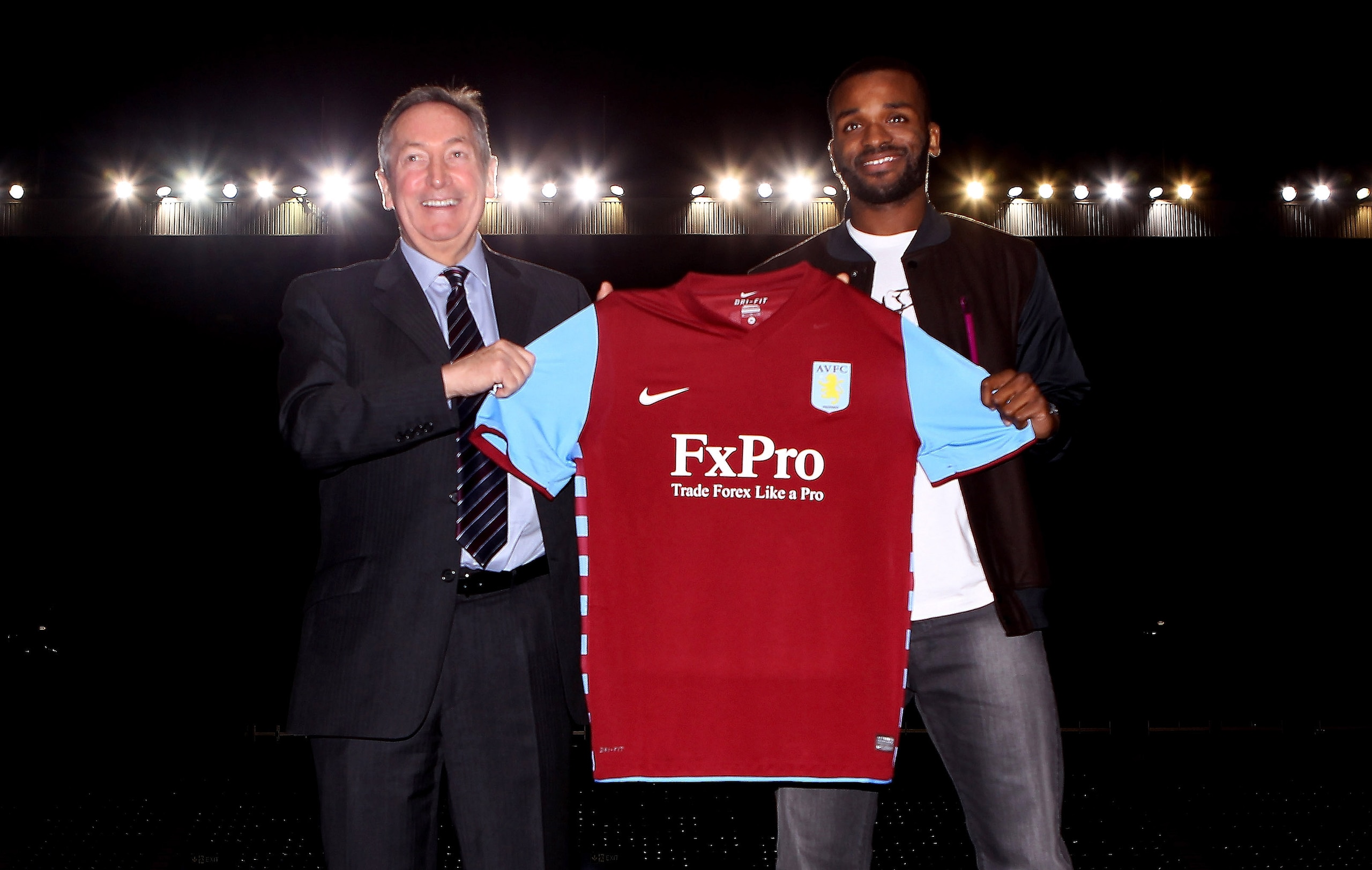 BIRMINGHAM, ENGLAND - JANUARY 18:  Darren Bent (R) and manager Gerrard Houllier hold the shirt during a press conference to announce him signing for Aston Villa at Villa Park on January 18, 2011 in Birmingham, England.  (Photo by Scott Heavey/Getty Images