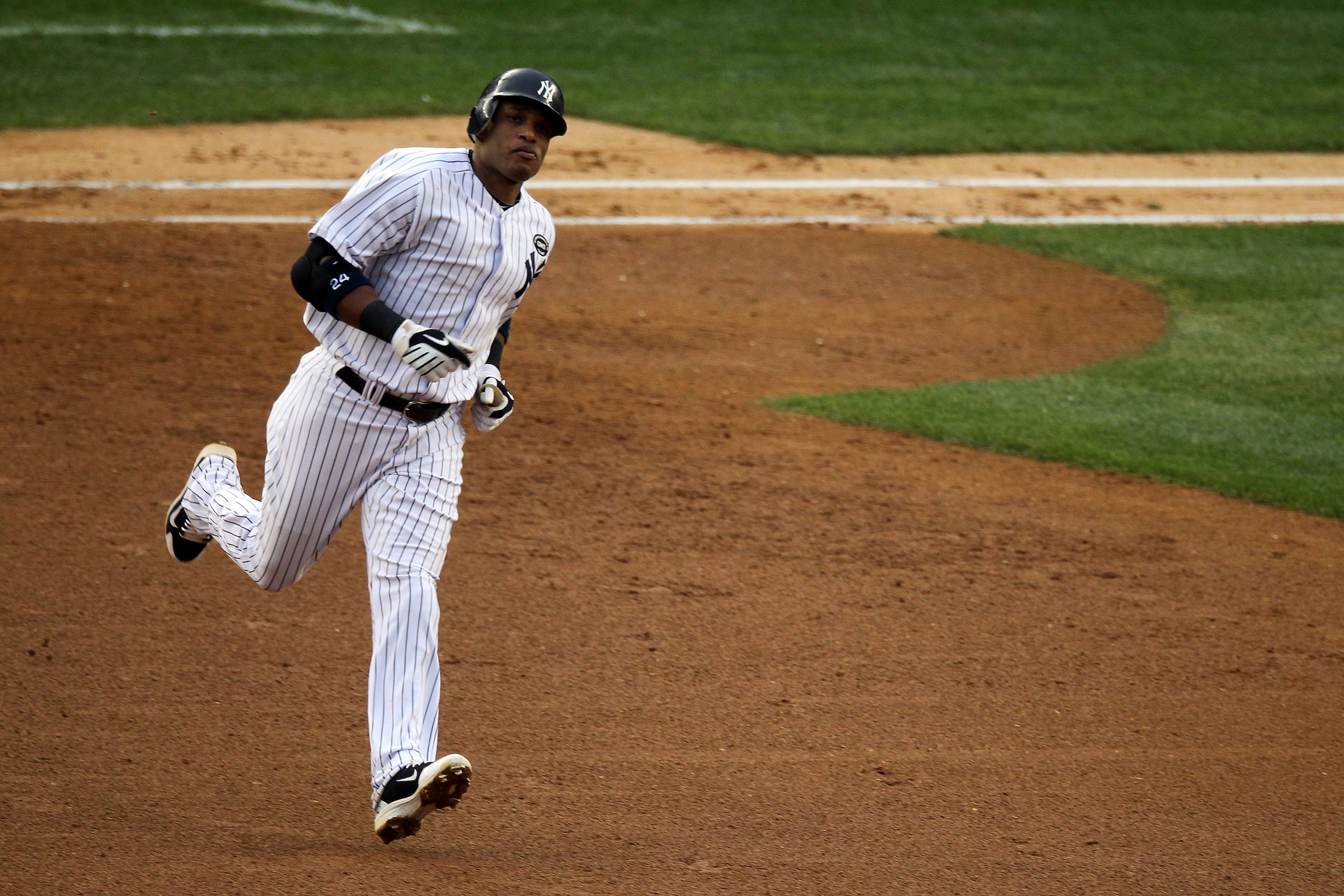 NEW YORK - OCTOBER 20: Robinson Cano #24 of the New York Yankees rounds the bases after hitting a solo home run in the third inning against the Texas Rangers in Game Five of the ALCS during the 2010 MLB Playoffs at Yankee Stadium on October 20, 2010 in t NEW YORK - OCTOBER 20: Robinson Cano #24 of the New York Yankees rounds the bases after hitting a solo home run in the third inning against the Texas Rangers in Game Five of the ALCS during the 2010 MLB Playoffs at Yankee Stadium on October 20, 2010 in t