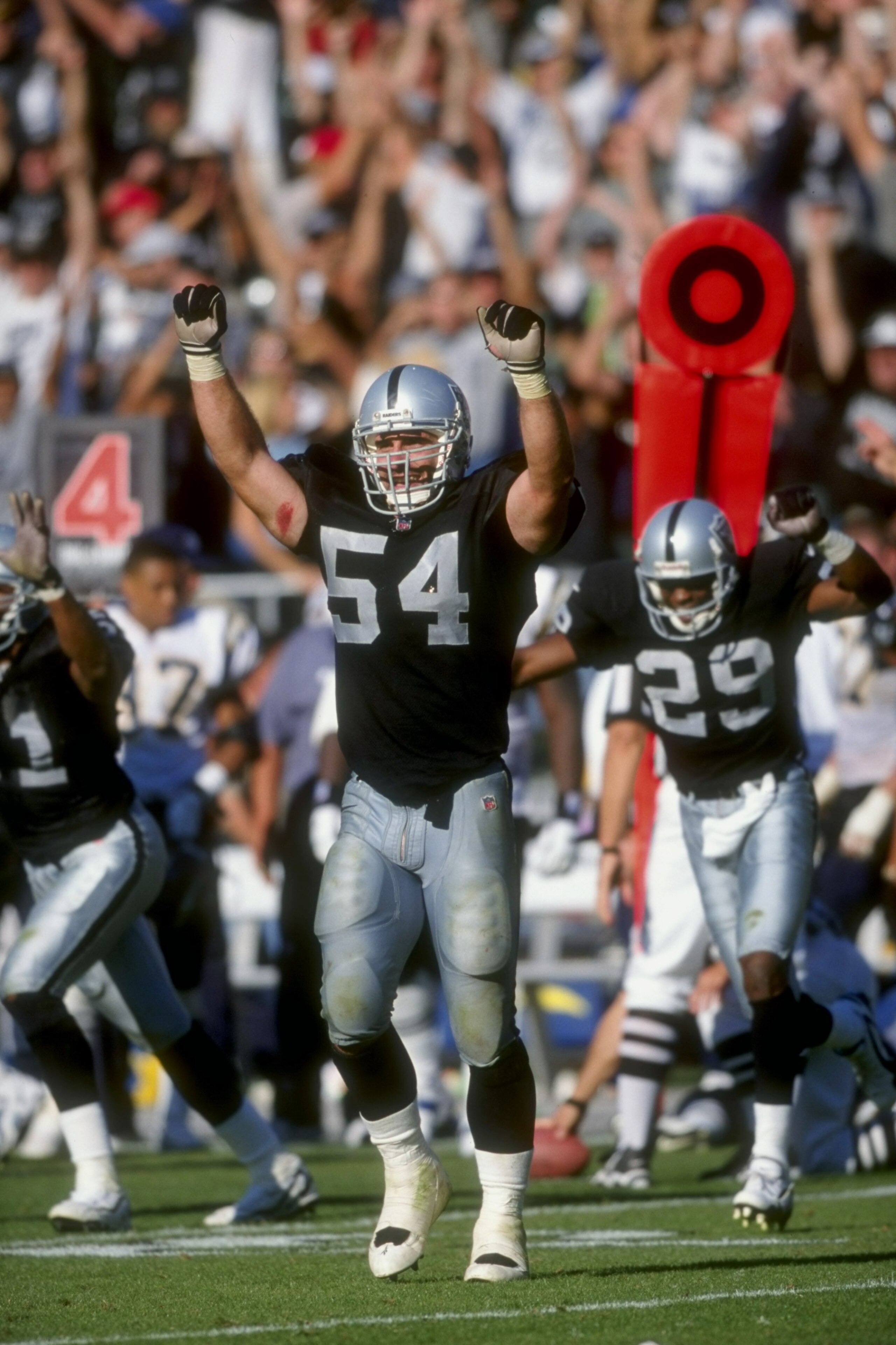 11 Oct 1998:  Greg Biekert #54 of the Oakland Raiders celebrates on the field during the game against the San Diego Chargers at Oakland Coliseum in Oakland, California.The Raiders defeated the Chargers 7-6. Mandatory Credit: David Taylor  /Allsport