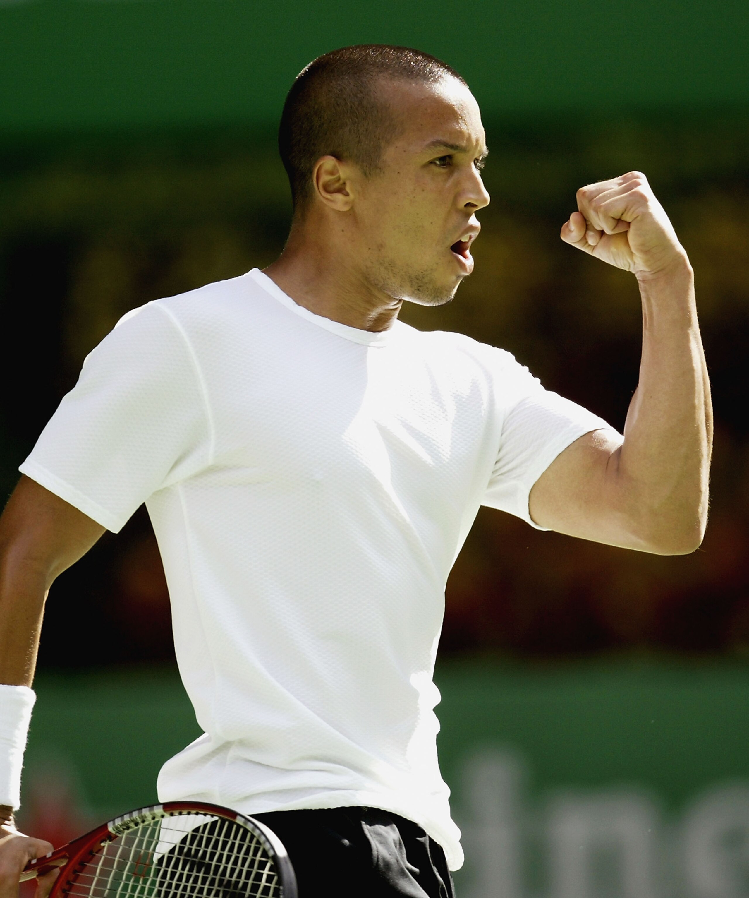 MELBOURNE, AUSTRALIA - JANUARY 26 : Hicham Arazi of Morocco celebrates a point against Mark Philippoussis of Australia during day eight of the Australian Open Grand Slam at Melbourne Park January 26, 2004 in Melbourne, Australia. (Photo by Getty Images)
