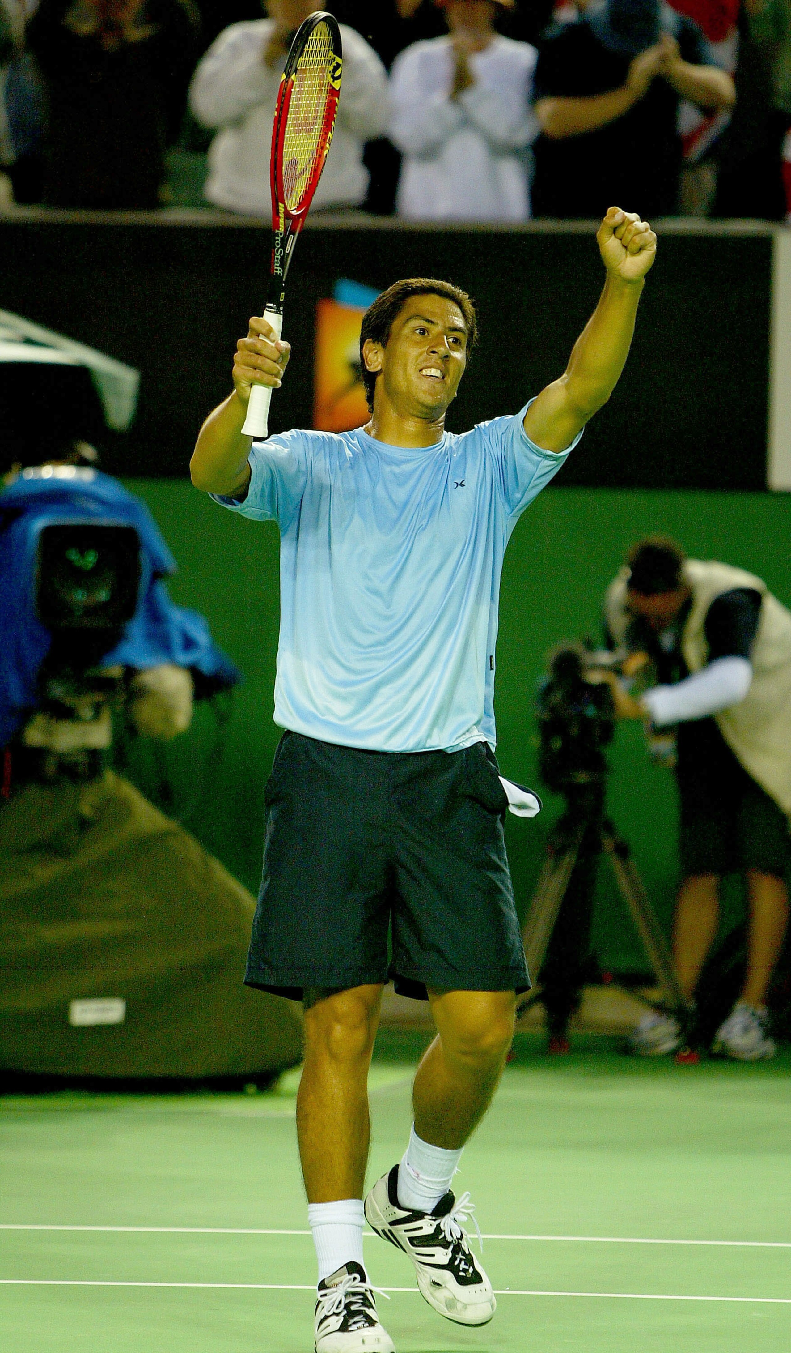 MELBOURNE, AUSTRALIA - JANUARY 24: Guillermo Canas of Argentina celebrates his victory over Tim Henman of Great Britain during day six of the Australian Open Grand Slam at Melbourne Park January 24, 2004 in Melbourne, Australia. (Photo by Clive Brunskill/
