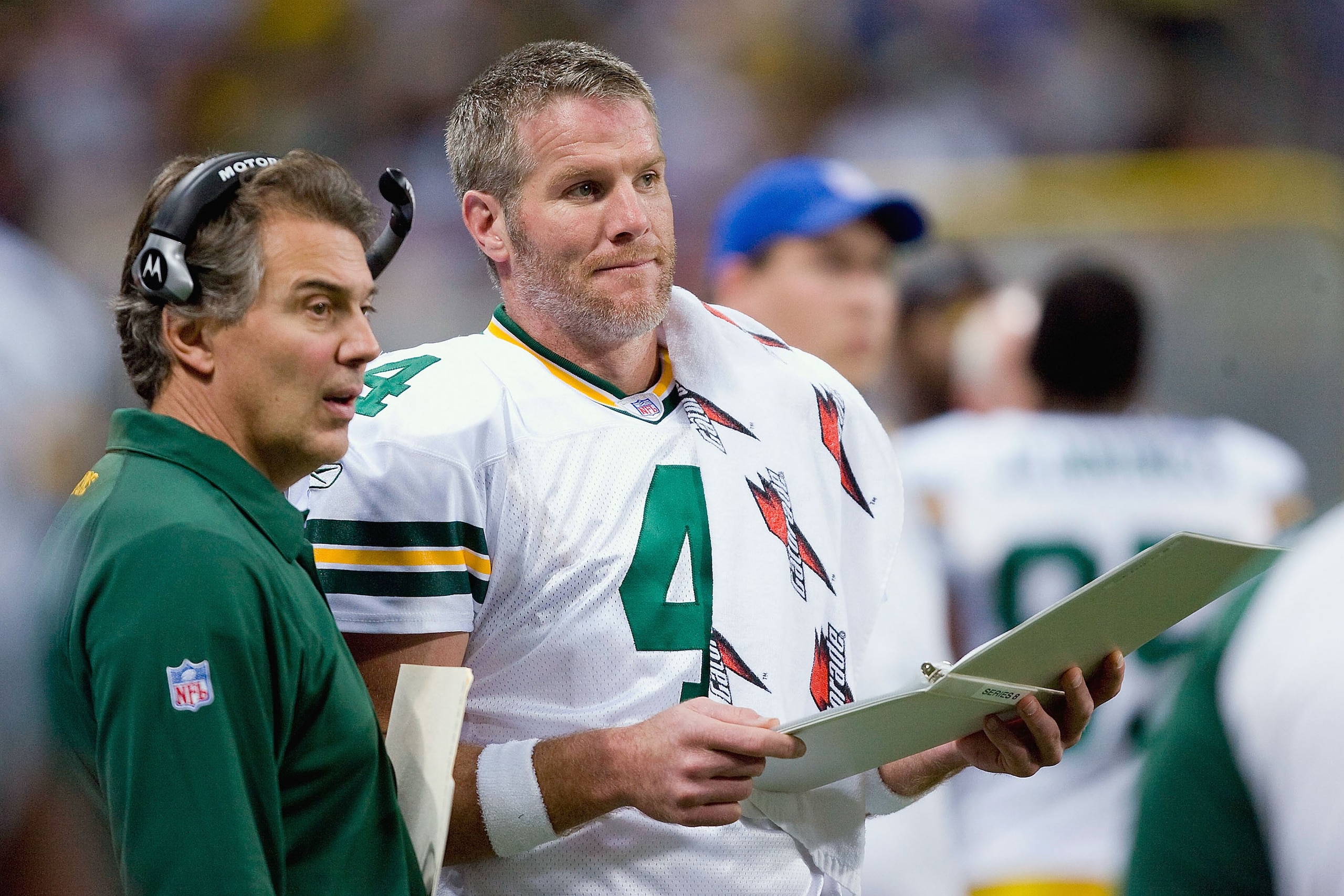 ST. LOUIS, MO - DECEMBER 16: Brett Favre #4 and Quarterback Coach Tom Clements of the Green Bay Packers look throught the playbook during the game against the St. Louis Rams on December 16, 2007 at the Edward Jones Dome in St. Louis, Missouri.  The Packer