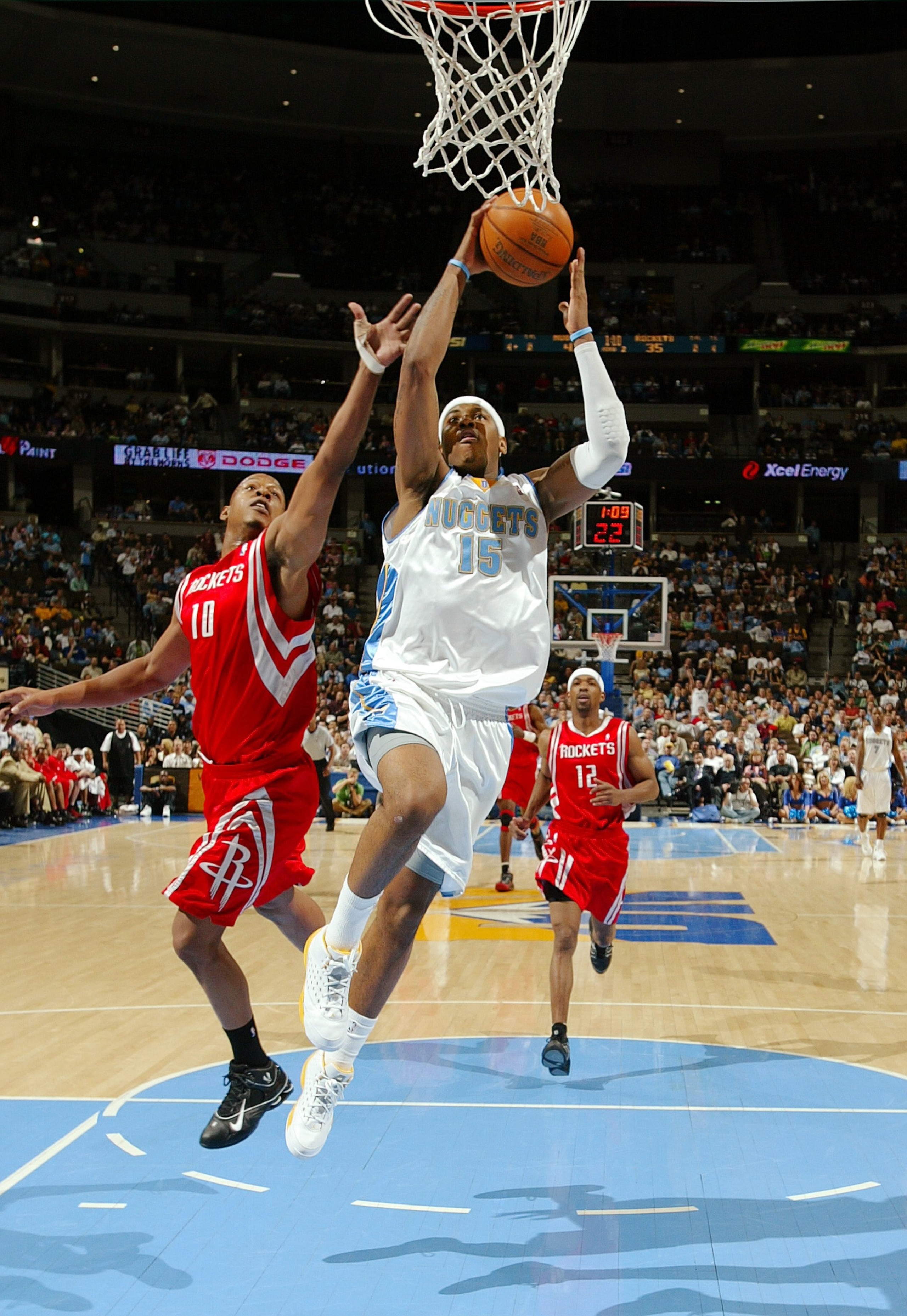 DENVER - APRIL 17: Carmelo Anthony #15 of the Denver Nuggets flies to the basket against Keith Bogans #10 of the Houston Rockets in the second quarter on April 17, 2006 at the Pepsi Center in Denver, Colorado. NOTE TO USER: USER expressly acknowledges a DENVER - APRIL 17: Carmelo Anthony #15 of the Denver Nuggets flies to the basket against Keith Bogans #10 of the Houston Rockets in the second quarter on April 17, 2006 at the Pepsi Center in Denver, Colorado. NOTE TO USER: USER expressly acknowledges a