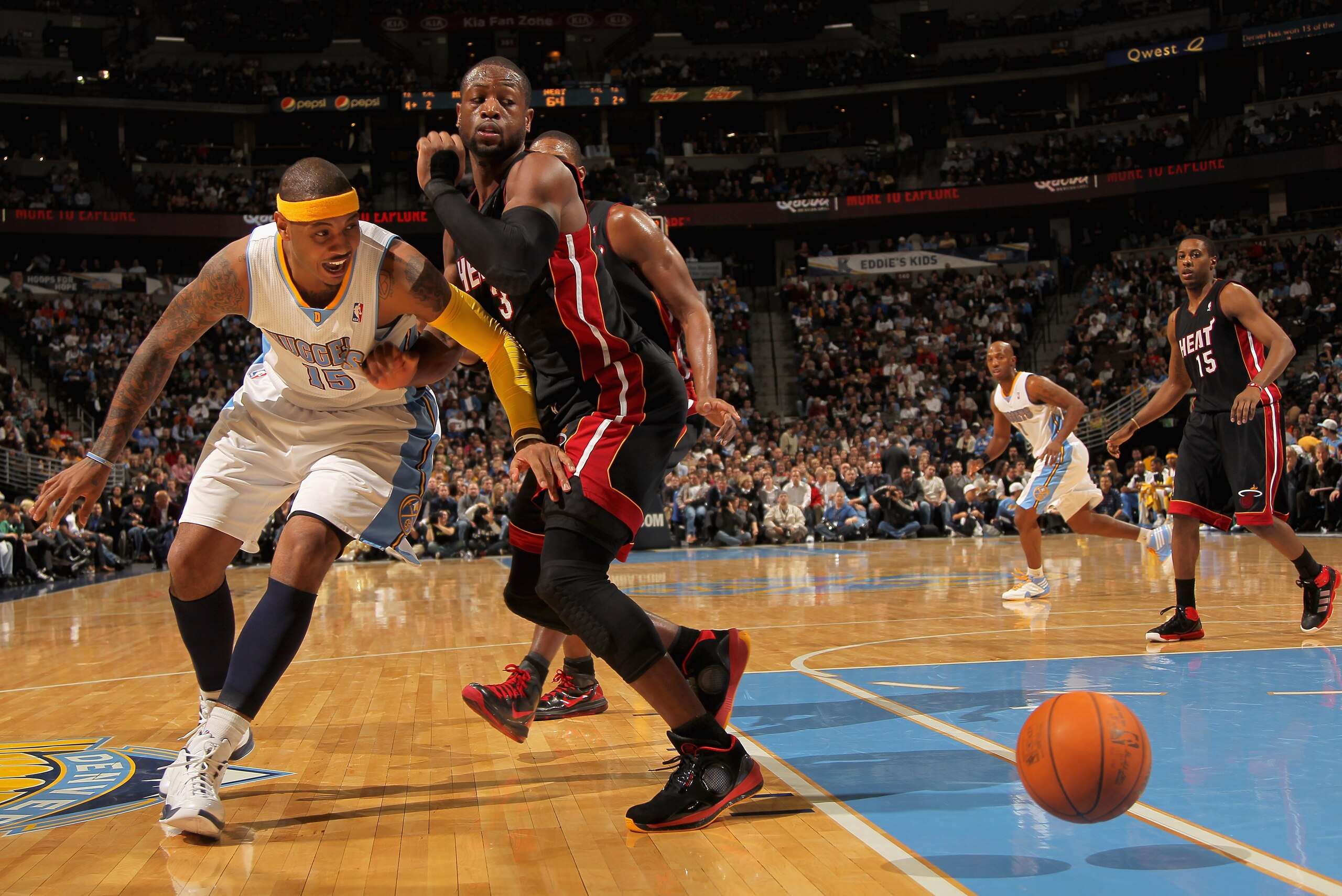 DENVER, CO - JANUARY 13:  Carmelo Anthony #15 of the Denver Nuggets looses control of the ball as Dwayne Wade #3 of the Miami Heat defends at the Pepsi Center on January 13, 2011 in Denver, Colorado. The Nuggets defeated the Heat 130-102. NOTE TO USER: Us