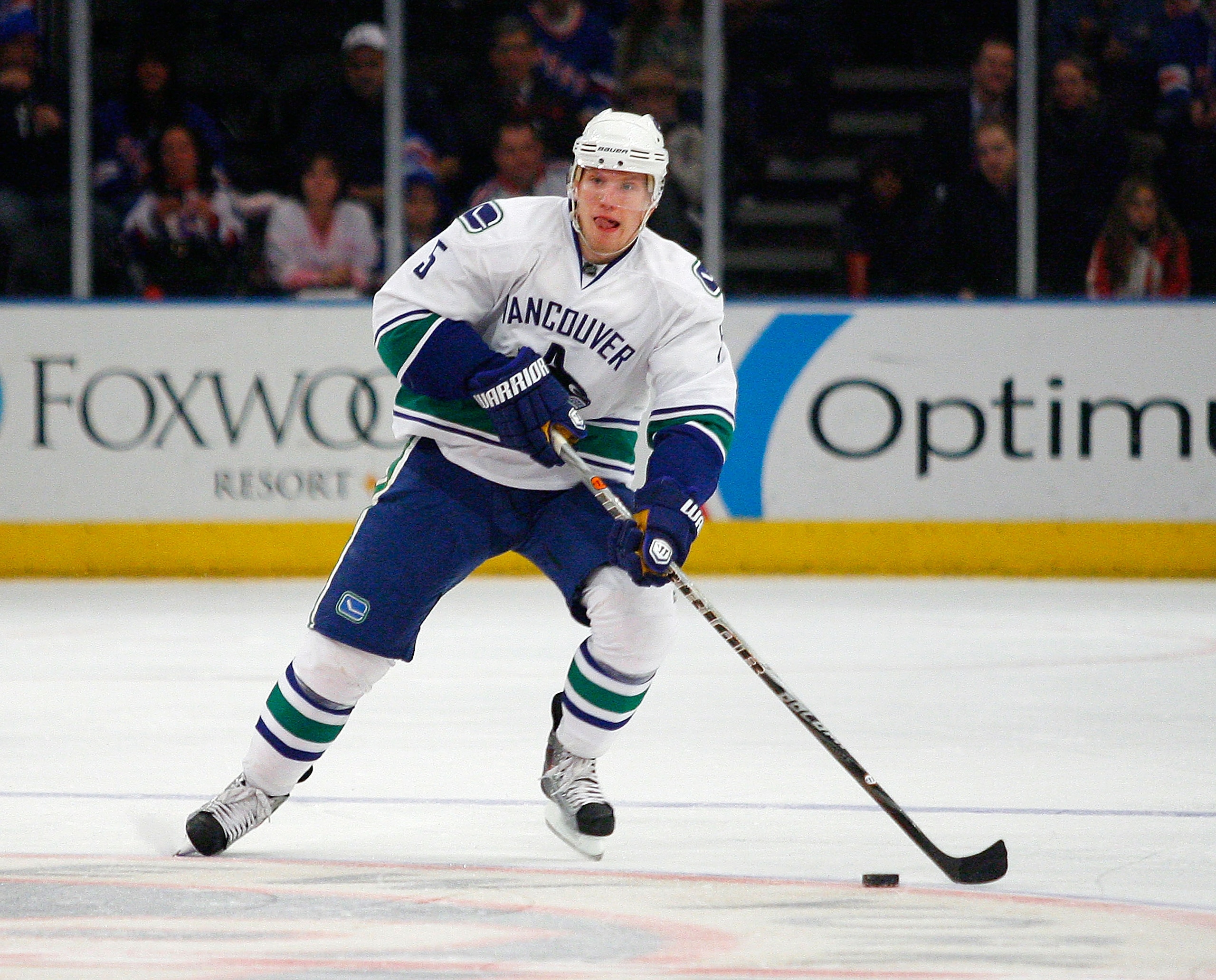 NEW YORK , NY - JANUARY 13: Christian Ehrhoff #5 of the Vancouver Canucks plays the puck against the New York Rangers during the game at Madison Square Garden on January 13, 2011 in New York City.  (Photo by Andy Marlin/Getty Images)