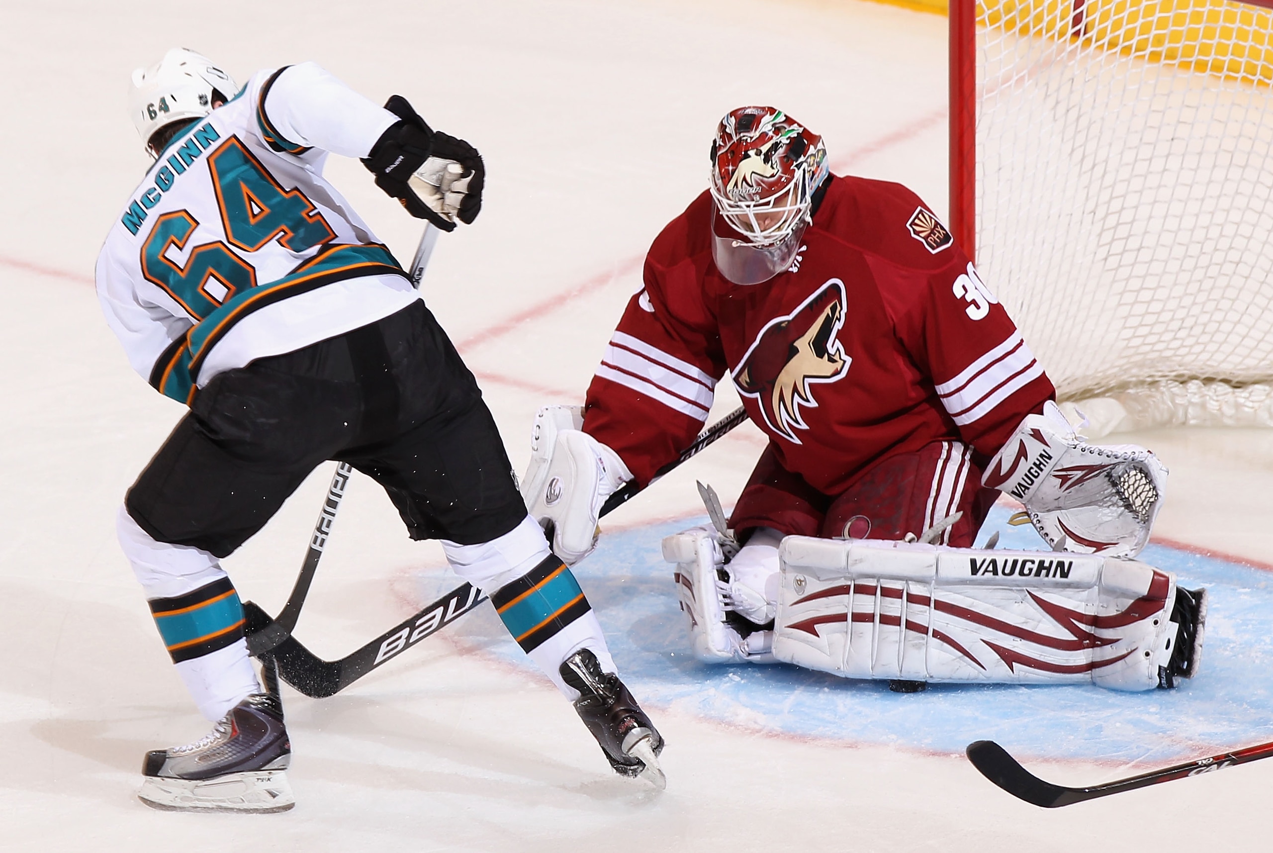 GLENDALE, AZ - JANUARY 17:  Goaltender Ilya Bryzgalov #30 of the Phoenix Coyotes makes a pad save on the shot from Jamie McGinn #64 of the San Jose Sharks during the second period of the NHL game at Jobing.com Arena on January 17, 2011 in Glendale, Arizon