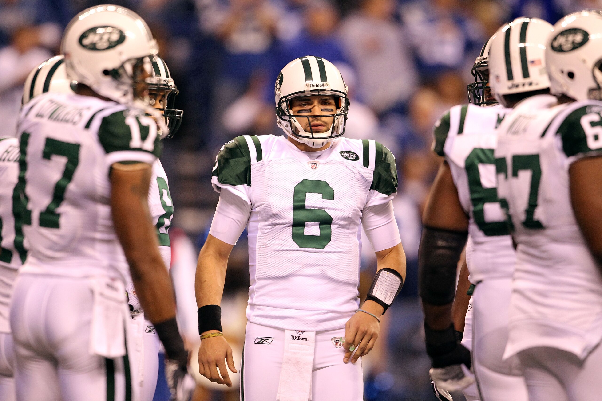 INDIANAPOLIS, IN - JANUARY 08:  Quarterback Mark Sanchez #6 of the New York Jets looks as the Jets get in an offensive huddel against the Indianapolis Colts during their 2011 AFC wild card playoff game at Lucas Oil Stadium on January 8, 2011 in Indianapol