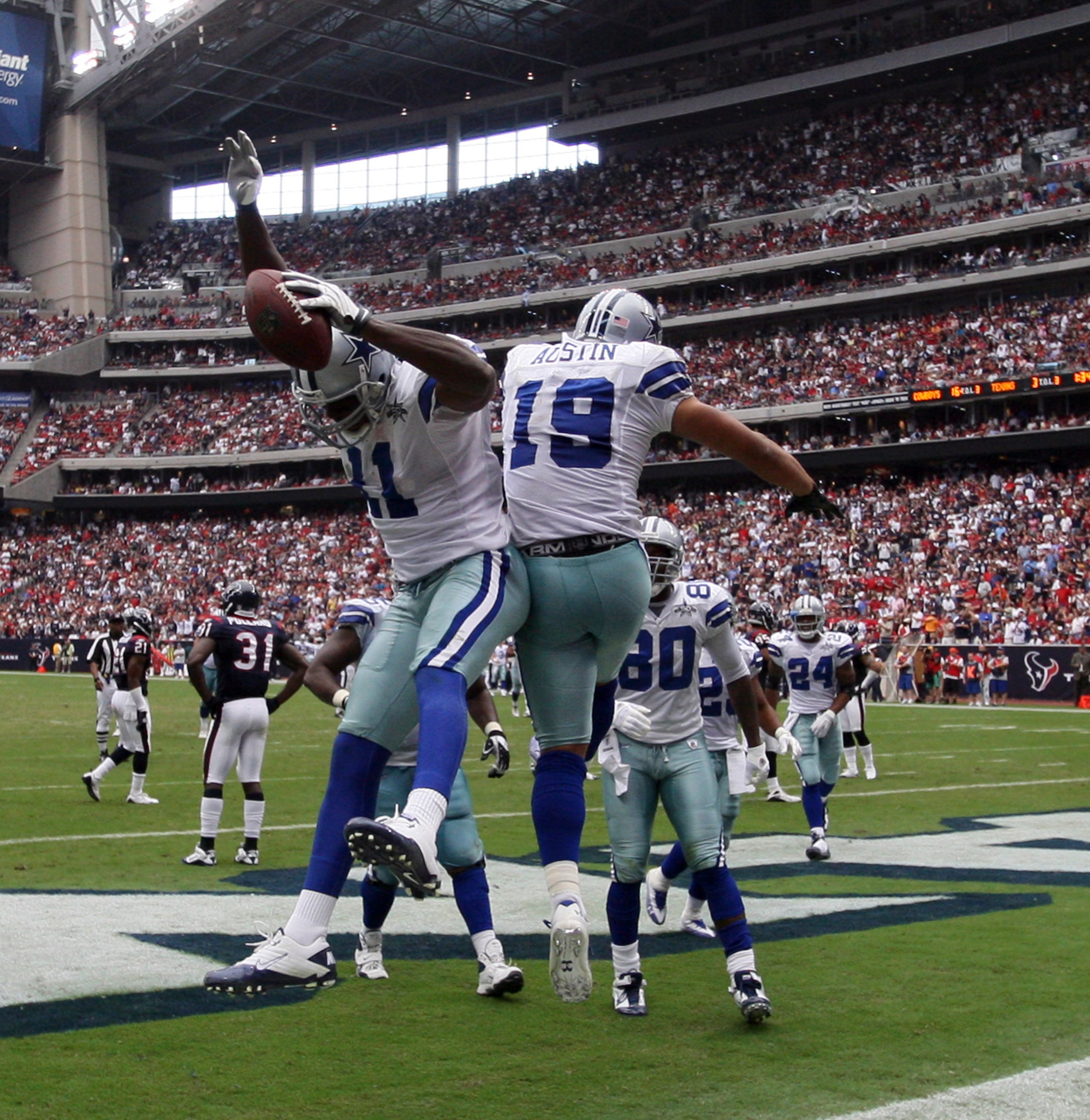 HOUSTON - SEPTEMBER 26:  Wide receiver Roy Williams #11 and Miles Austin #11 celebrate after scoring on a 15 yard pass from Tony Romo in the third quarter at Reliant Stadium on September 26, 2010 in Houston, Texas.  (Photo by Bob Levey/Getty Images)