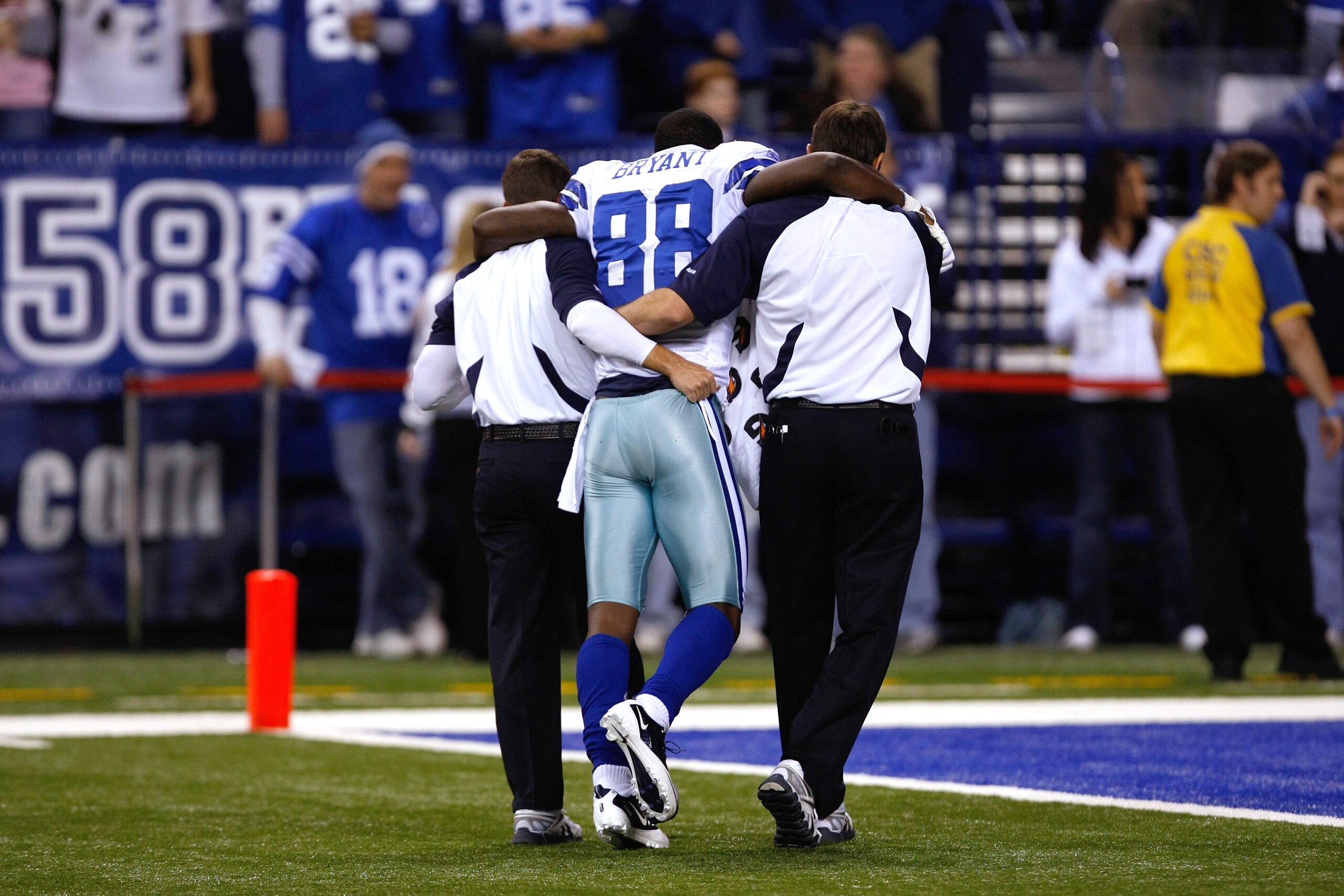 INDIANAPOLIS, IN - DECEMBER 05: Dez Bryant #88 of the Dallas Cowboys is helped off the field after an injury against the Indianapolis Colts at Lucas Oil Stadium on December 5, 2010 in Indianapolis, Indiana. The Cowboys defeated the Colts 38-35 in overtime