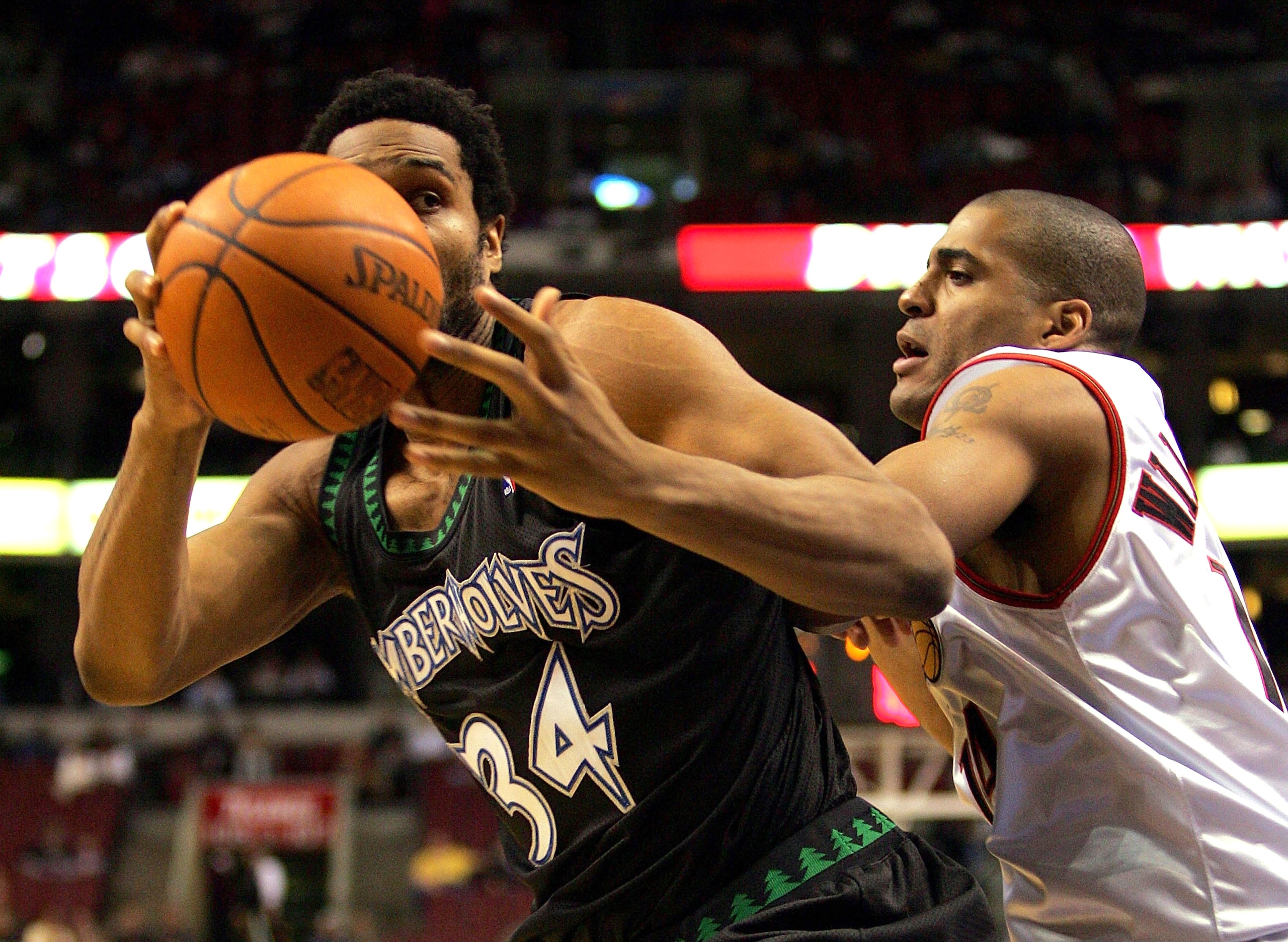 PHILADELPHIA - DECEMBER 8:  Michael Olowokandi #34 of the Minnesota Timberwolves grabs a loose ball against Corliss Williamson #14 of the Philadelphia 76ers during the first half of the game at the Wachovia Center on December 8, 2004 in Philadelphia, Penn