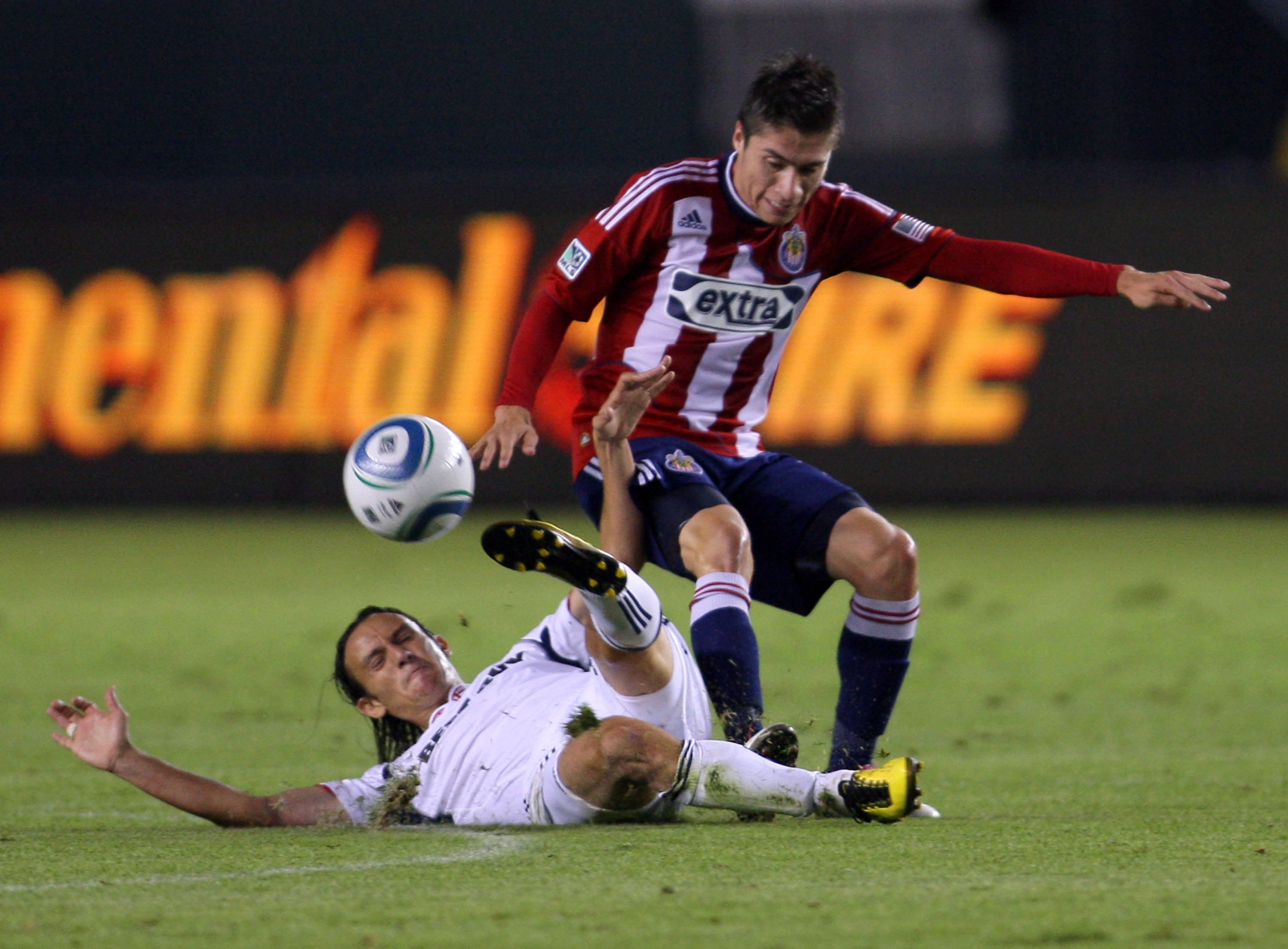 CARSON, CA - OCTOBER 23:  Jorge Flores #19 of Chivas USA and Bratislav Ristic #77 of the Chicago Fire vie for the ball in the first half during the MLS match on October 23, 2010 in Carson, California. The Fire defeated Chivas USA 4-1.  (Photo by Victor De