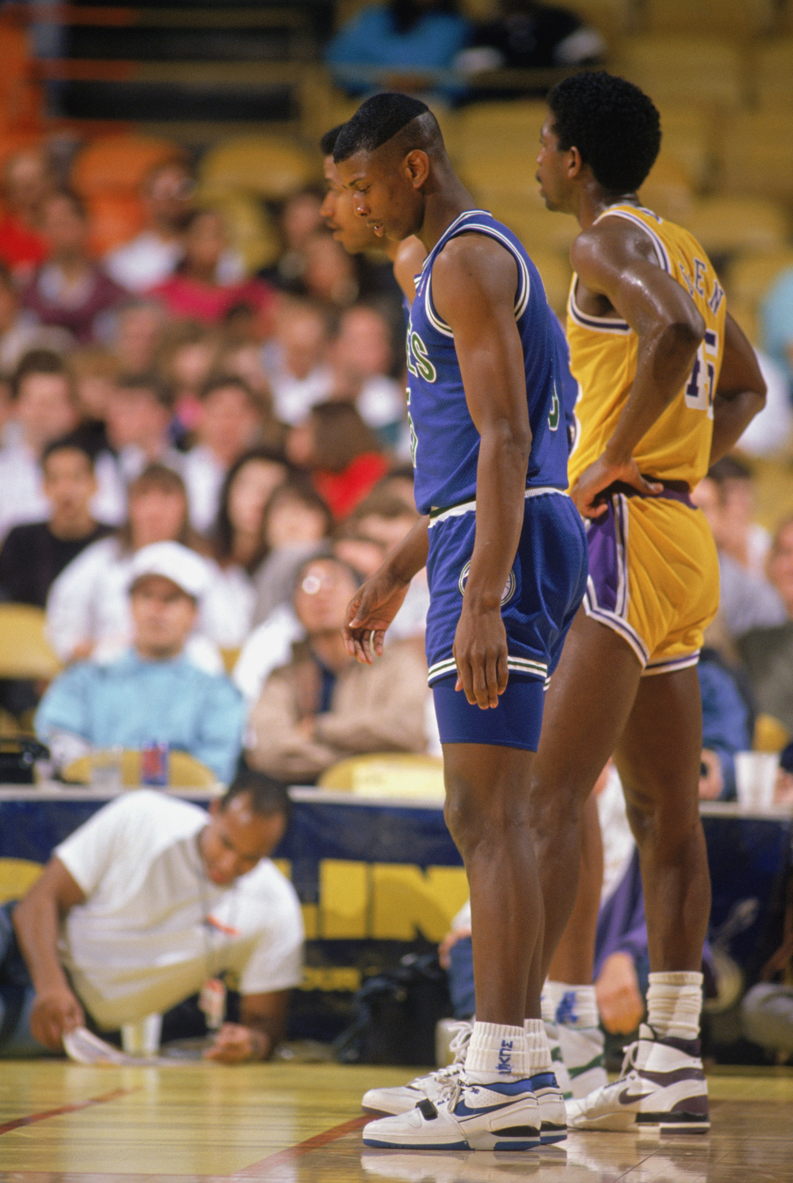 LOS ANGELES - 1990:  Doug West #5 of the Minnesota Timberwolves and A.C. Green #45 of the Los Angeles Lakers wait for the free-throws during a game at the Great Western Forum in Los Angeles, California during the 1989-1990 NBA season.  (Photo by Ken Levin