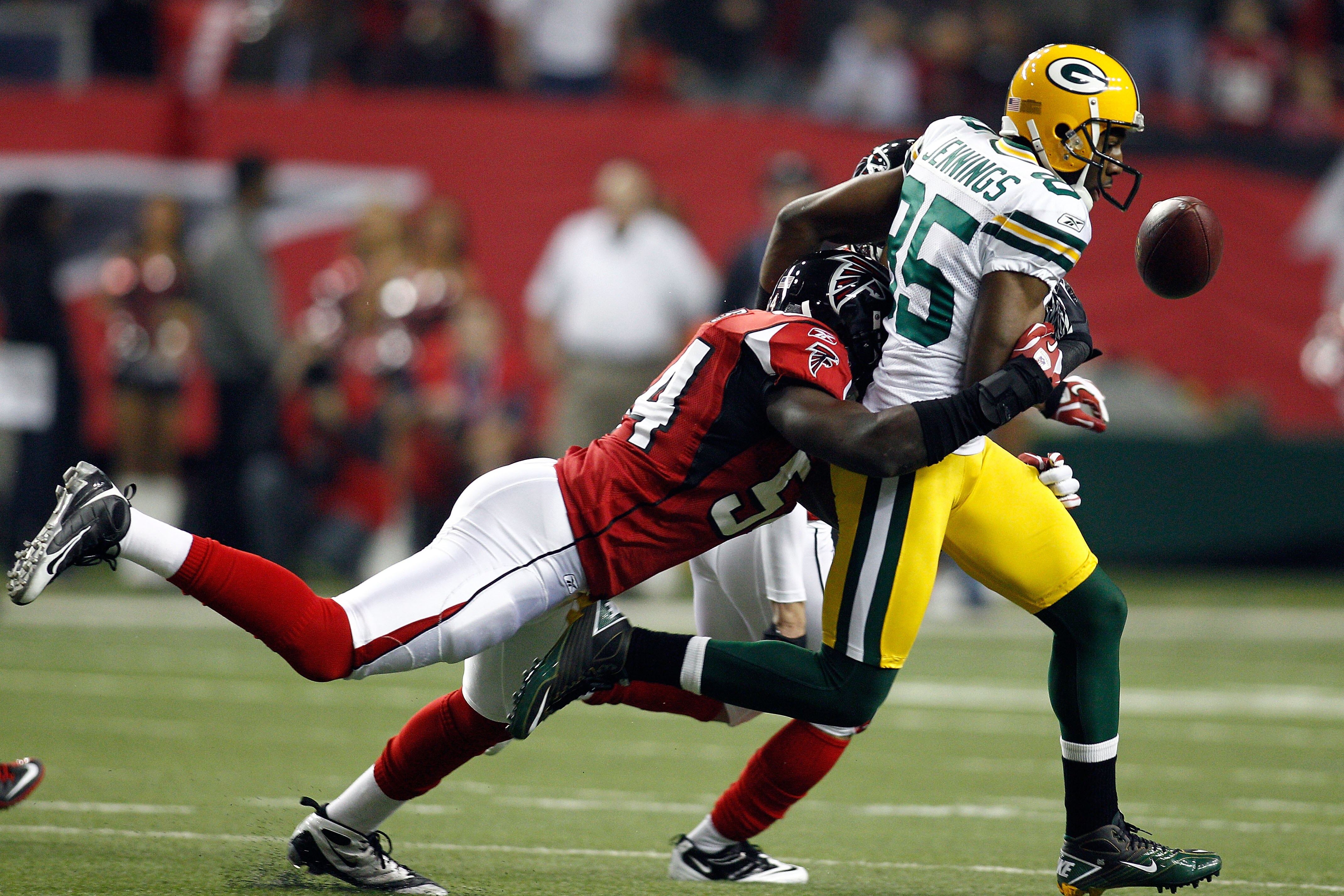 ATLANTA, GA - JANUARY 15:  Greg Jennings #85 of Green Bay Packers fumbles the ball in the first quarter against Stephen Nicholas #54 of the Atlanta Falcons during their 2011 NFC divisional playoff game at Georgia Dome on January 15, 2011 in Atlanta, Georg