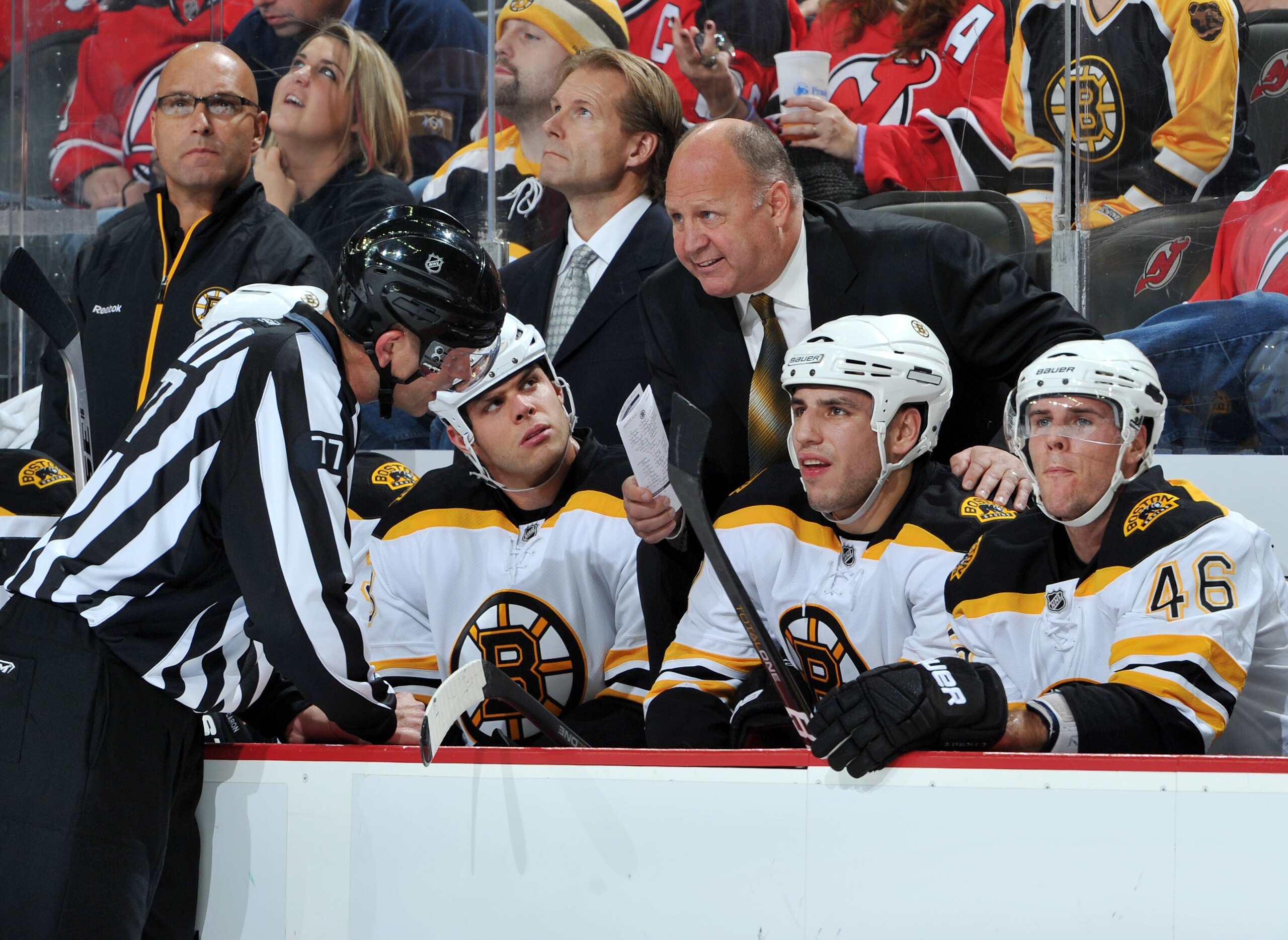 NEWARK, NJ - OCTOBER 11: Boston Bruins head coach Claude Julien (right) has a word with linesman Tim Nowak (left) during the first period at the Prudential Center on October 11, 2010 in Newark, New Jersey. The Bruins defeated the Devils 4-1. (Photo by Chr