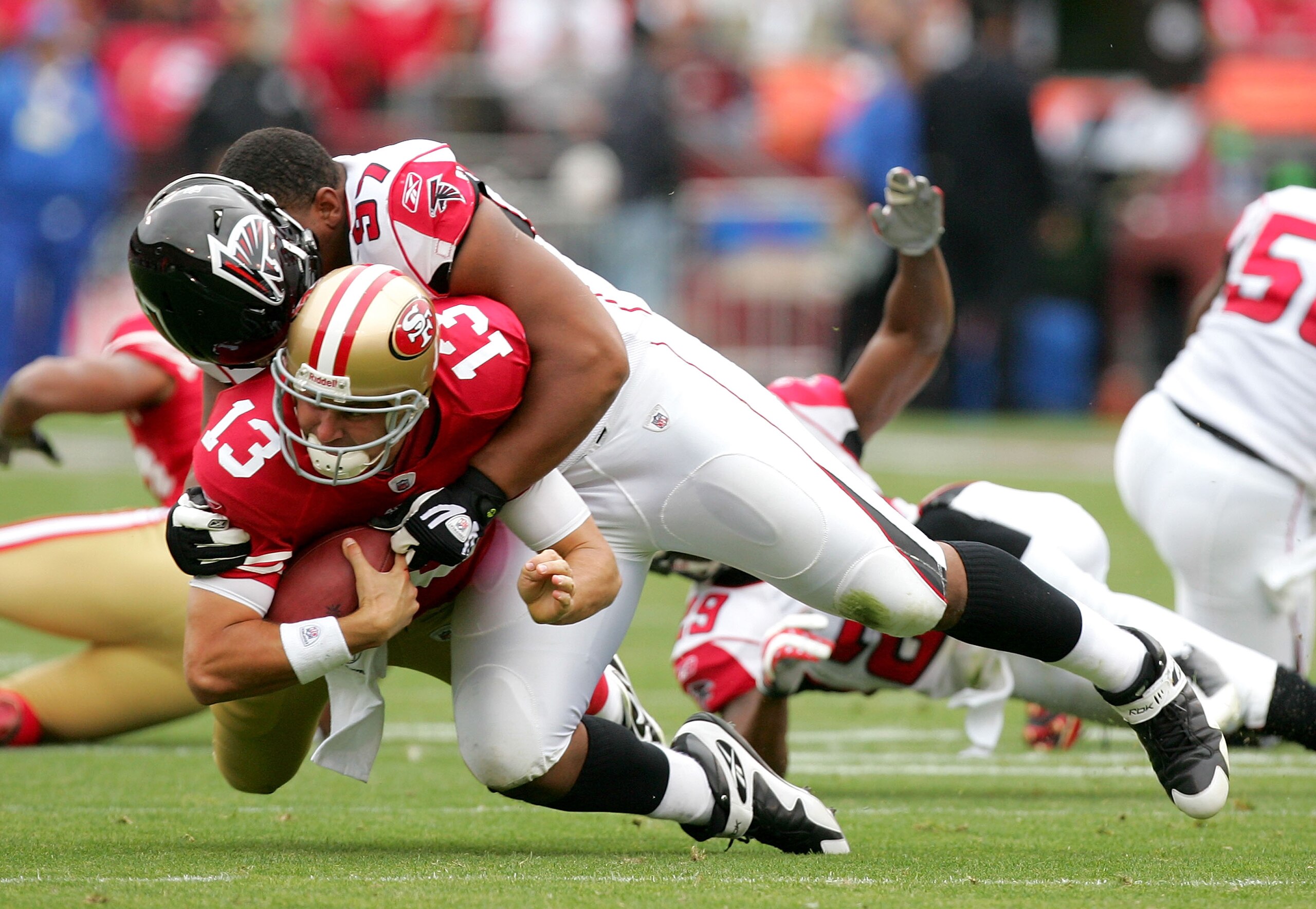 SAN FRANCISCO - OCTOBER 11:  Shaun Hill #13 ofthe San Francisco 49ers is tackled by Trey Lewis #97 of the Atlanta Falcons at Candlestick Park on October 11, 2009 in San Francisco, California.  (Photo by Ezra Shaw/Getty Images)