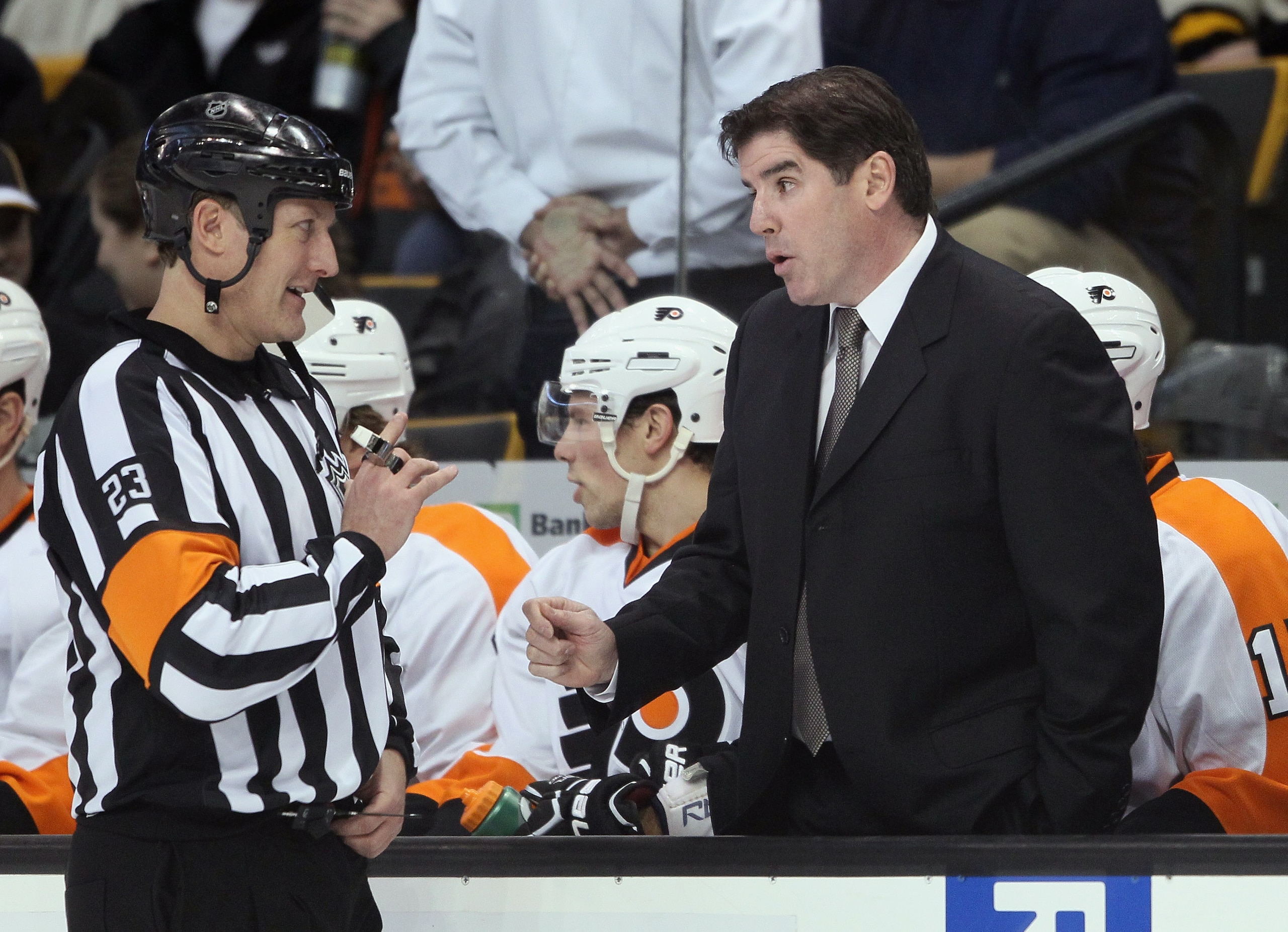 BOSTON, MA - JANUARY 13:  Head coach Peter Laviolette of the Philadelphia Flyers talks with referee Brad Watson before the start of the second period against the Boston Bruins on January 11, 2011 at the TD Garden in Boston, Massachusetts.  (Photo by Elsa/