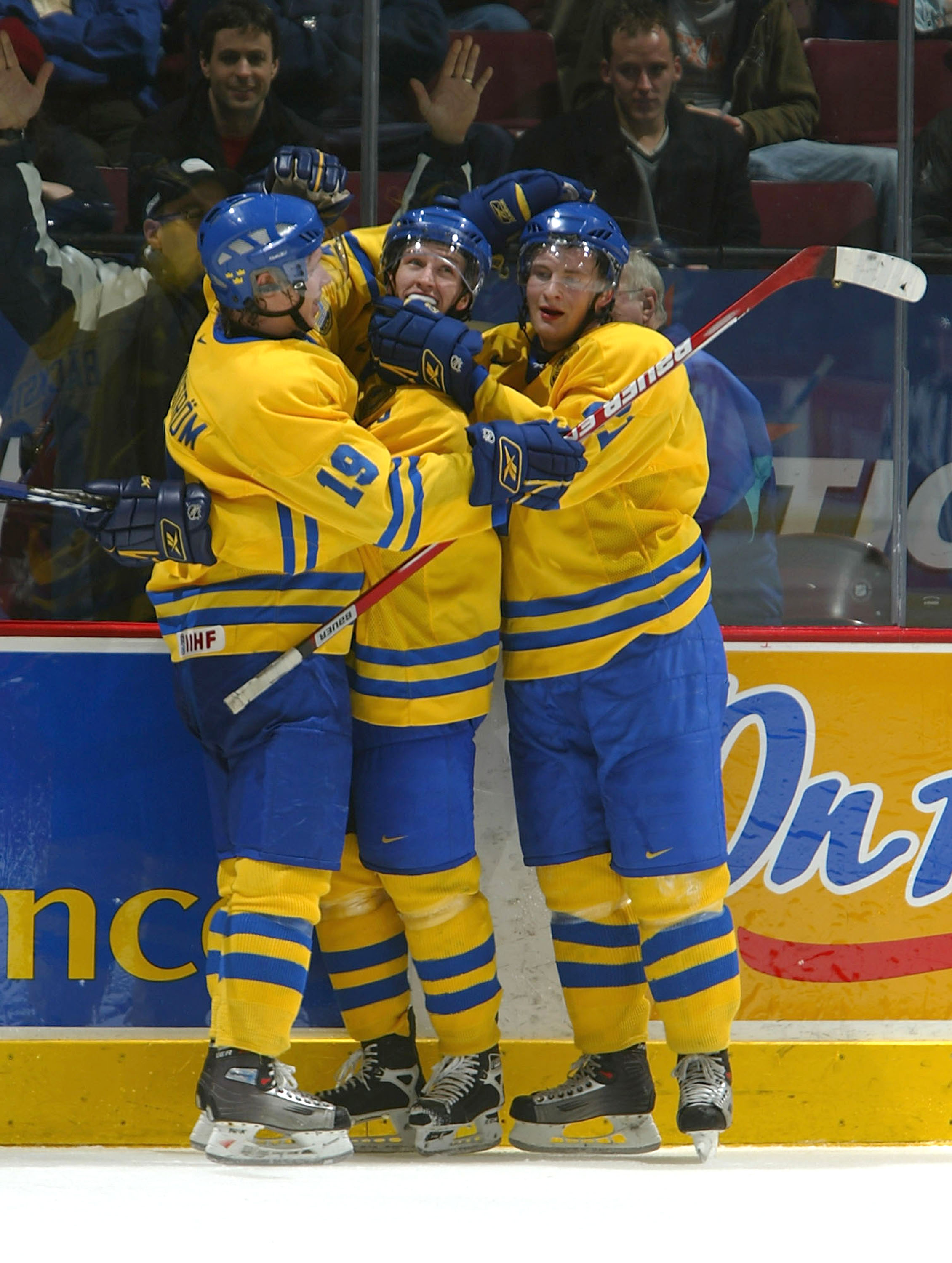 VANCOUVER - JANUARY 4:  Nicklas Bergfors #19, Mattias Ritola #21, both of Team Sweden, congratulate teammate Sebastian Karlsson #3 after he scored an empty net goal during their World Jr. Hockey Championship 5th place game on January 4, 2006 at General Mo