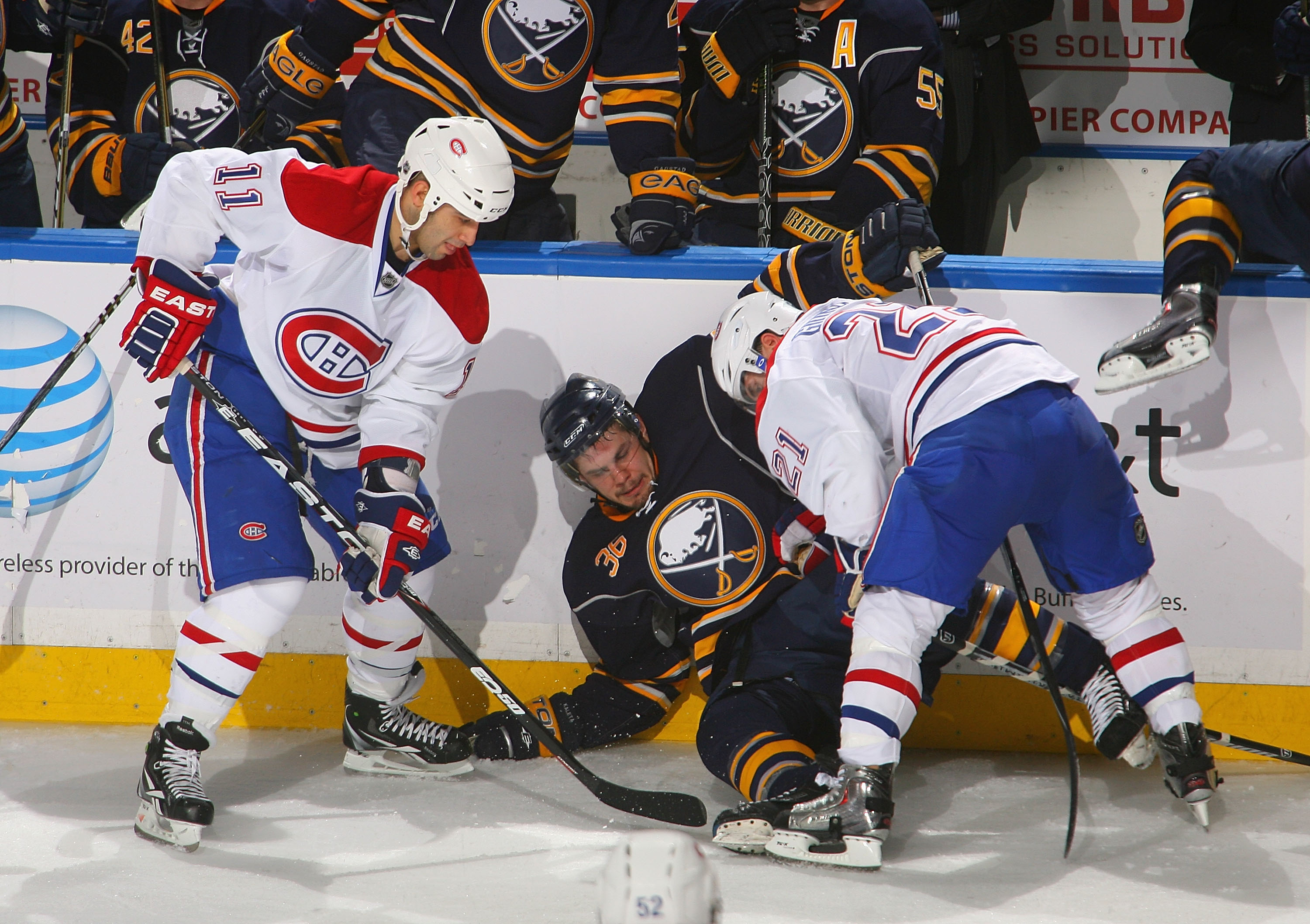 BUFFALO, NY - JANUARY 18: Scott Gomez #11 and Brian Gionta #21 of the Montreal Canadiens trap Patrick Kaleta #36 of the Buffalo Sabres against the boards at HSBC Arena on January 18, 2011 in Buffalo, New York.  (Photo by Rick Stewart/Getty Images)