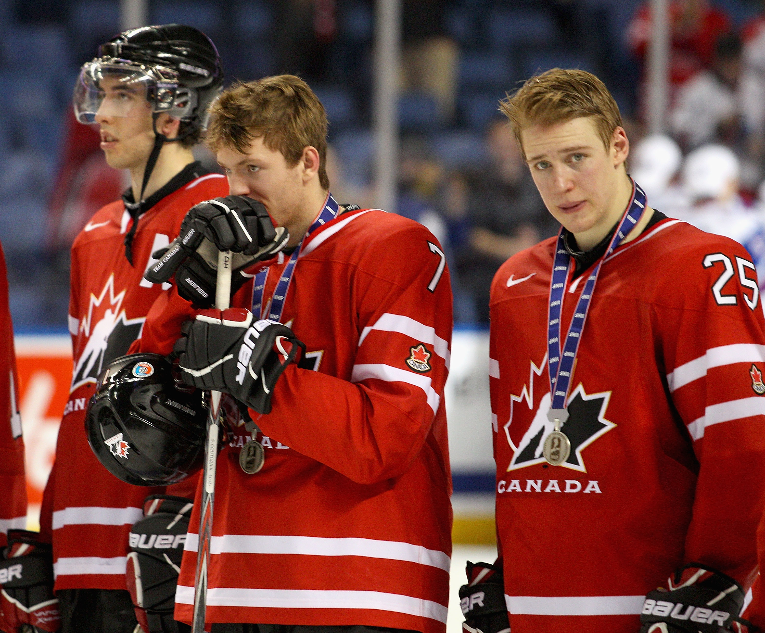 BUFFALO, NY - JANUARY 05: Jared Cowen #2, Sean Couturier #7 and Carter Ashton #25 of Canada stand on the ice during medal ceremonies after losing to Russia 5-3 during the 2011 IIHF World U20 Championship Gold medal game between Canada and Russia at the HS