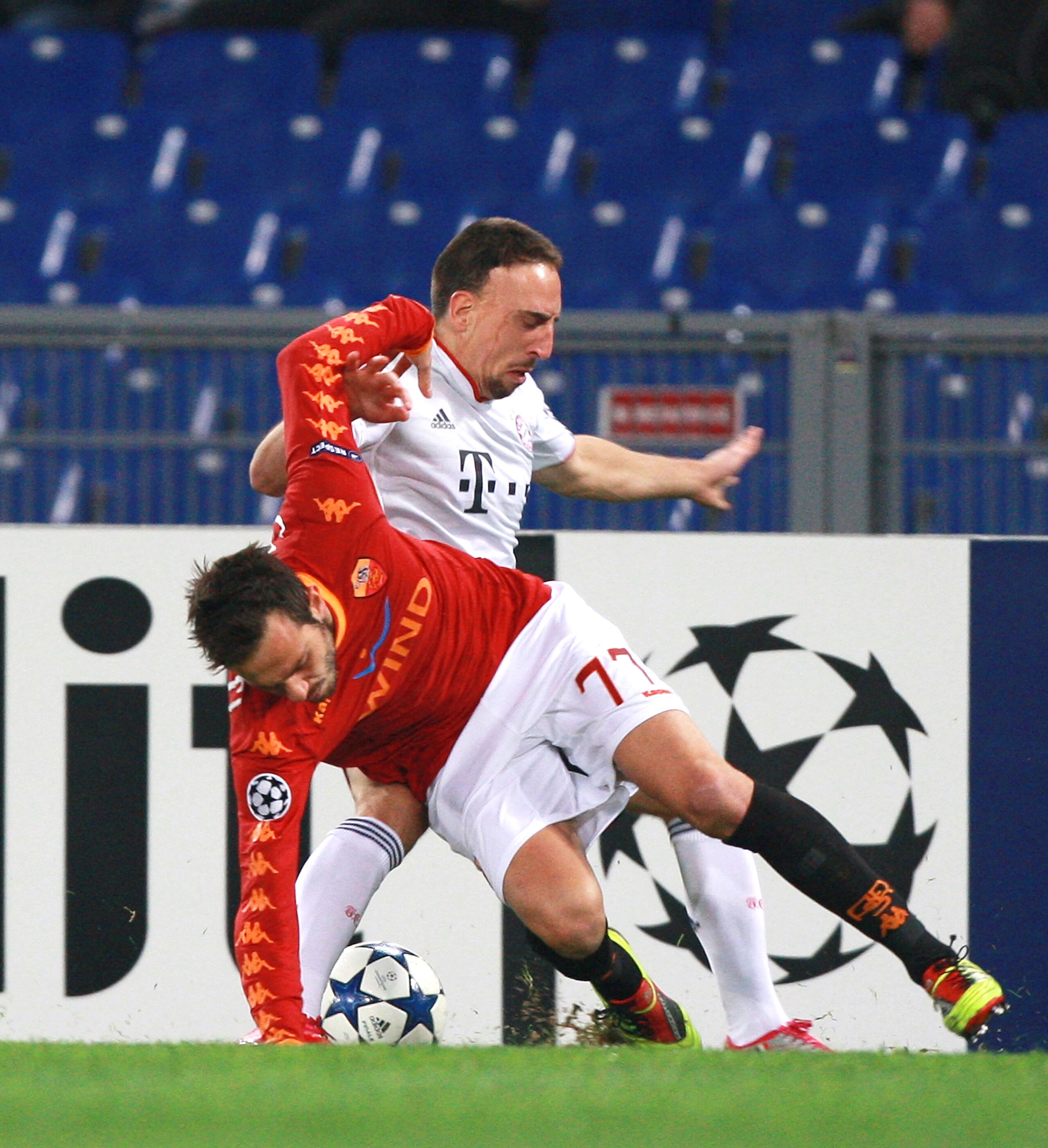 ROME - NOVEMBER 23:  Franck Ribery (UP) of FC Bayern Muenchen competes for the ball with Marco Cassetti of AS Roma during the UEFA Champions League Group E match between AS Roma and FC Bayern Muenchen at Stadio Olimpico on November 23, 2010 in Rome, Italy