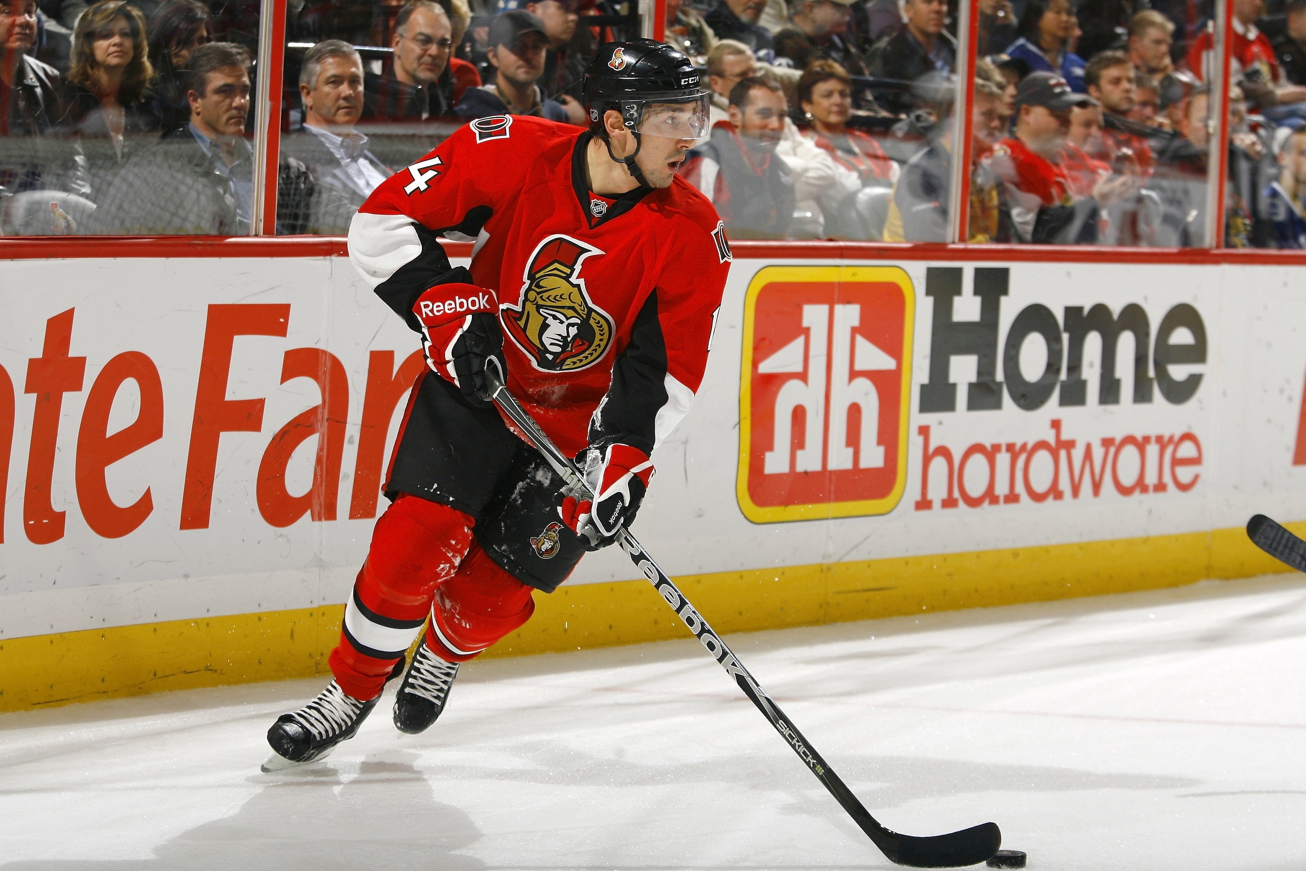 OTTAWA, CANADA - NOVEMBER 11:  Chris Campoli #14 of the Ottawa Senators turs up ice with the puck during a game against the Vancouver Canucks at Scotiabank Place on November 11, 2010 in Ottawa, Ontario, Canada.  (Photo by Phillip MacCallum/Getty Images)