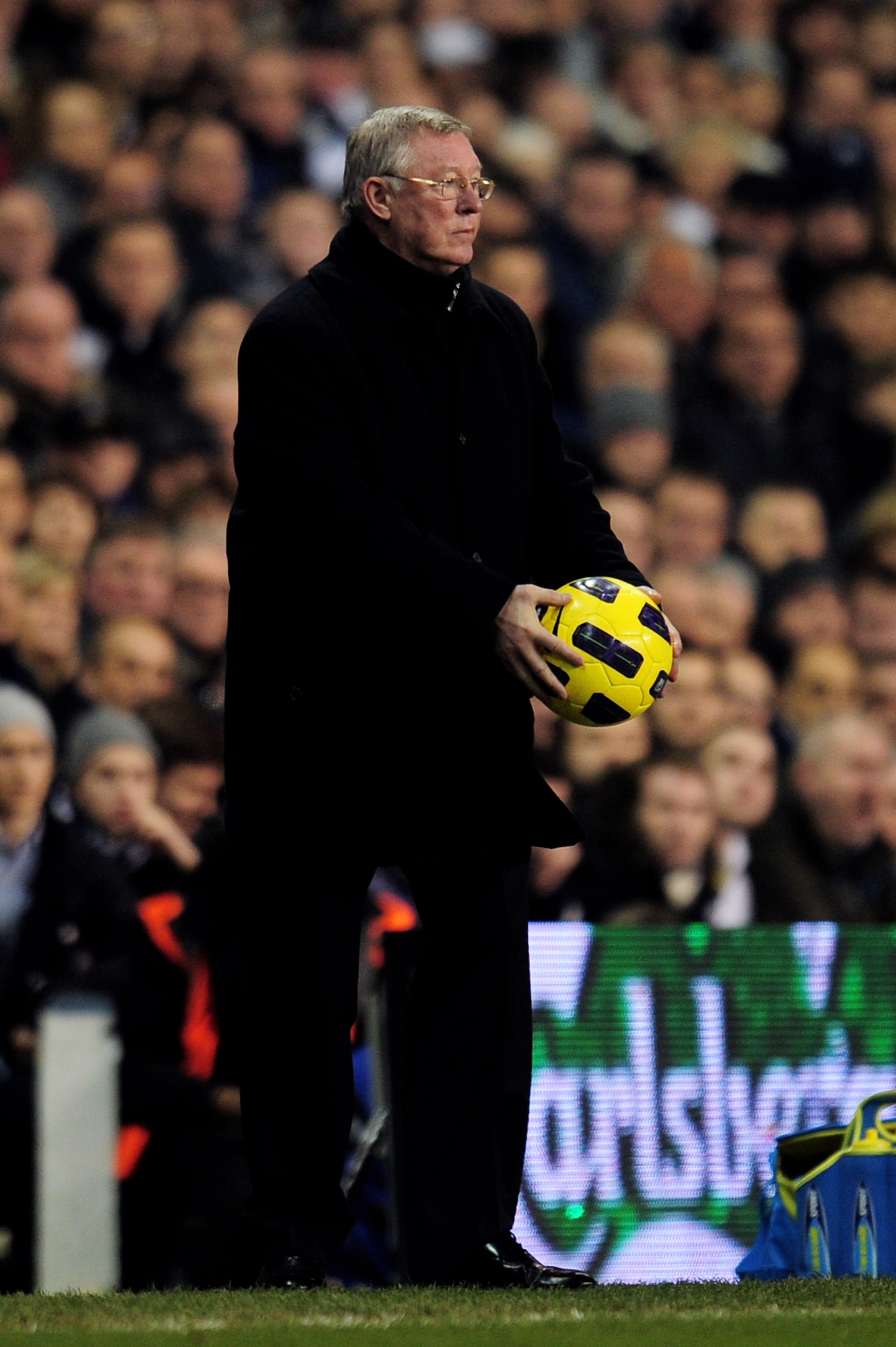 LONDON, ENGLAND - JANUARY 16:  Sir Alex Ferguson the Manchester United manager handles the ball during the Barclays Premier League match between Tottenham Hotspur and Manchester United at White Hart Lane on January 16, 2011 in London, England.  (Photo by
