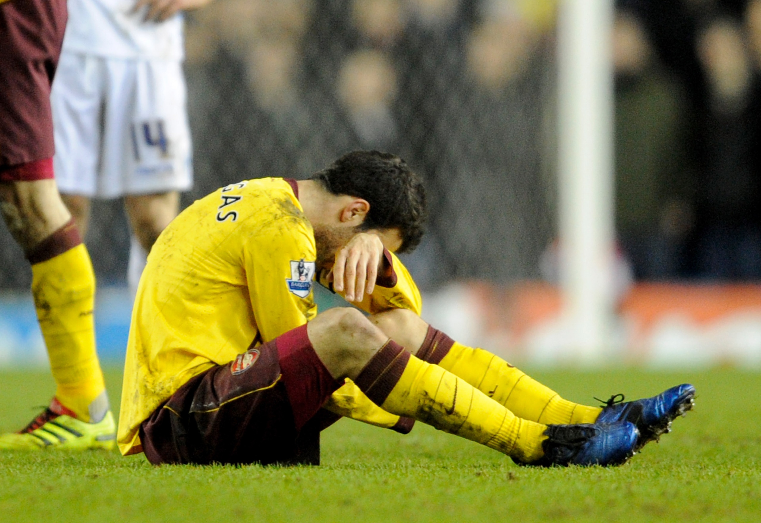 LEEDS, UNITED KINGDOM - JANUARY 19:   Cesc Fabregas of Arsenal goes down injured during the FA Cup sponsored by E.On Third Round Replay match between Leeds United and Arsenal at Elland Road on January 19, 2011 in Leeds, England. (Photo by Michael Regan/Ge