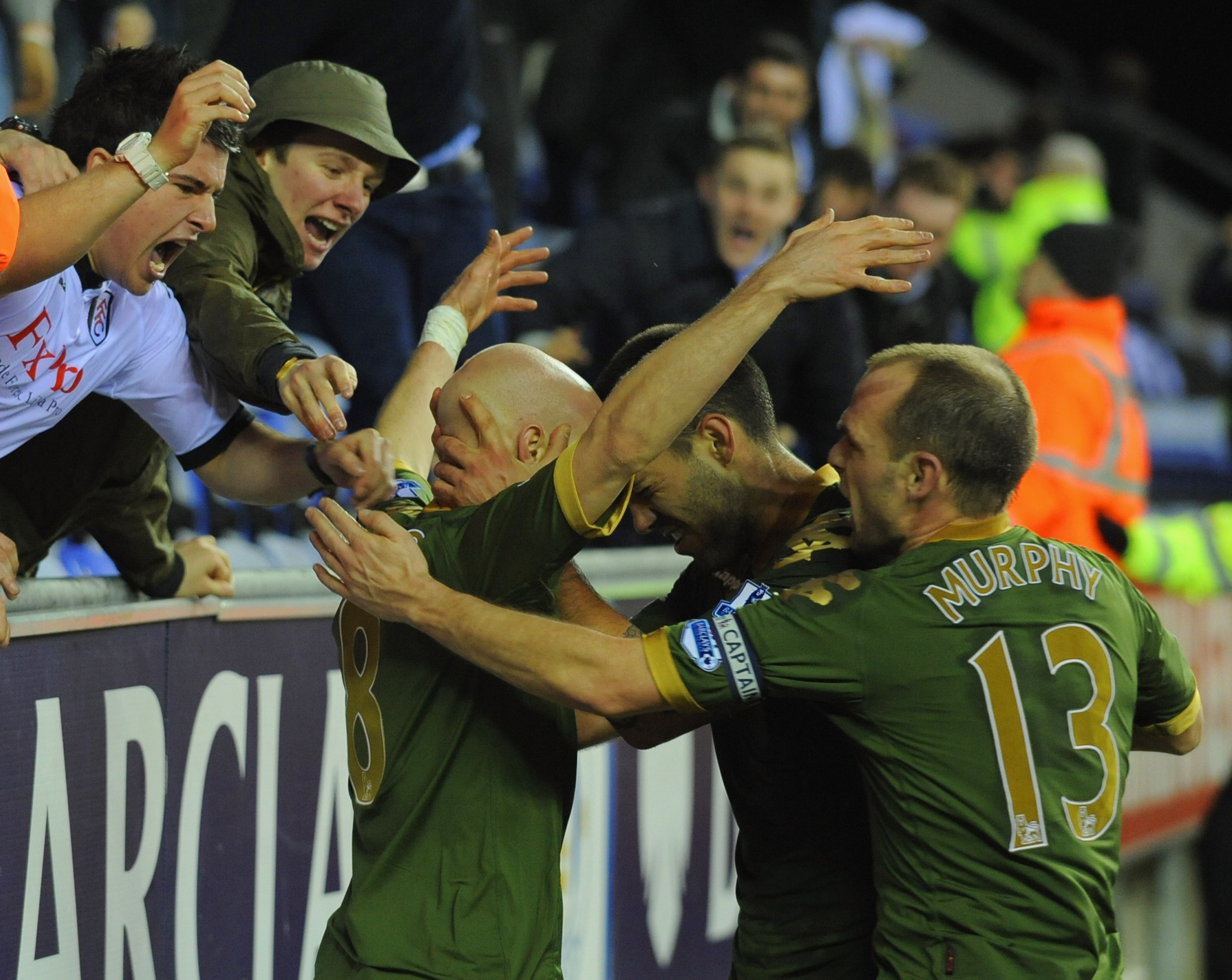 WIGAN, ENGLAND - JANUARY 15: Andy Johnson of Fulham celebrates scoring to make it 1-1 with Clint Dempsey and Danny Murphy during the Premier League match between Wigan Athletic and Fulham at the DW Stadium on January 15, 2011 in Wigan, England.  (Photo by