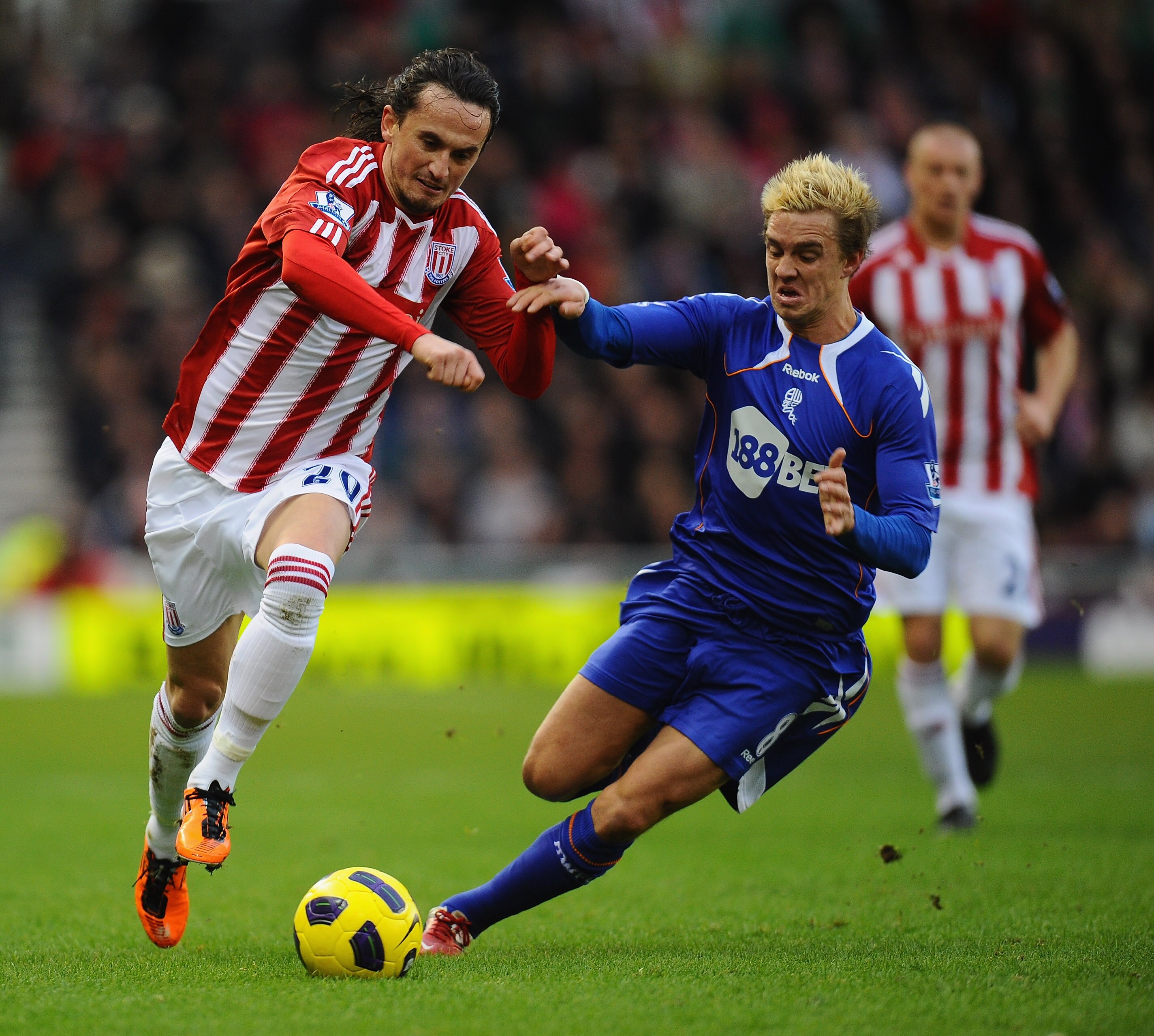 STOKE ON TRENT, ENGLAND - JANUARY 15:  Tuncay of Stoke City holds off a challenge from Stuart Holden of Bolton Wanderers during the Barclays Premier League match between Stoke City and Bolton Wanderers at Britannia Stadium on January 15, 2011 in Stoke on