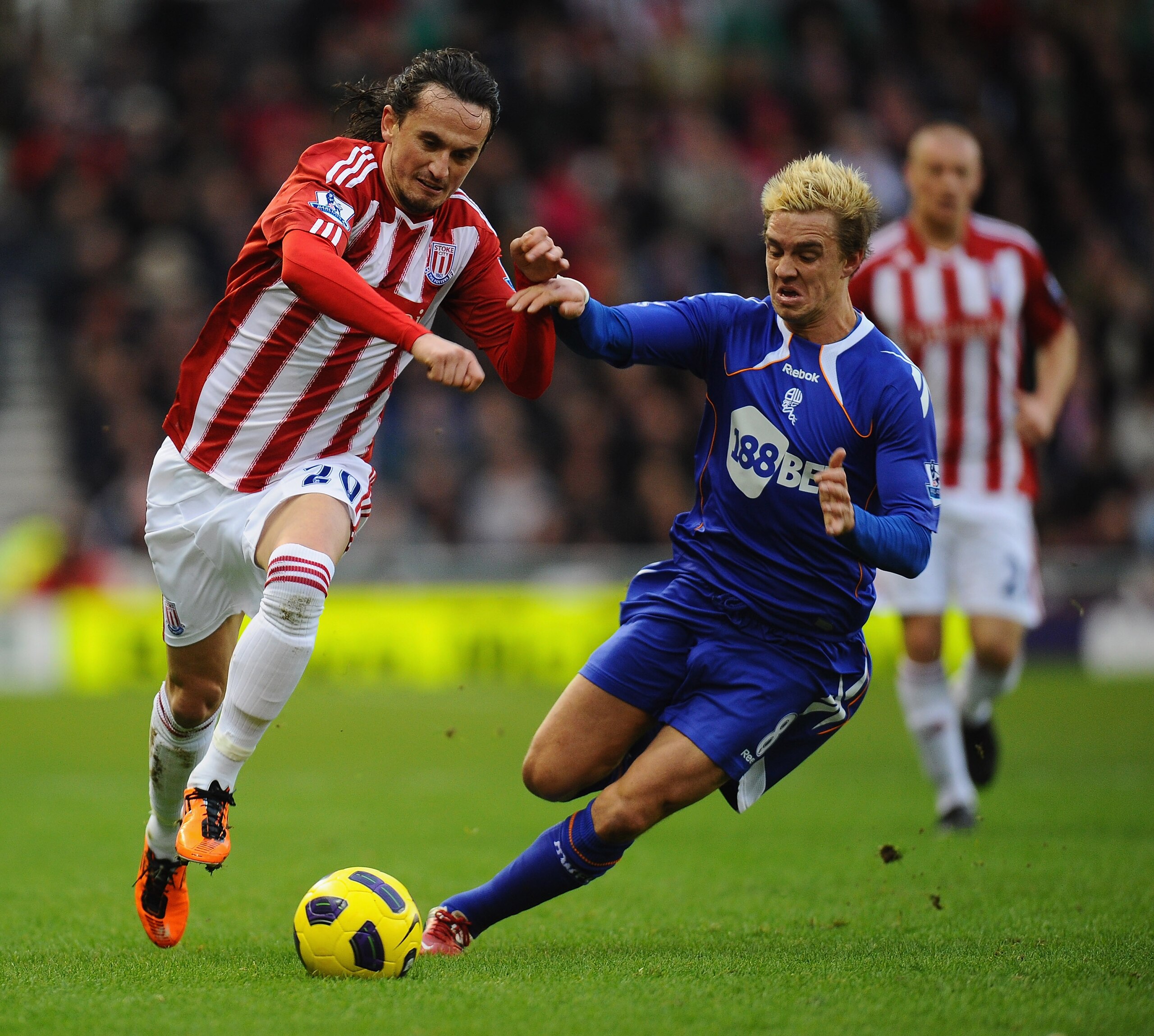 STOKE ON TRENT, ENGLAND - JANUARY 15:  Tuncay of Stoke City holds off a challenge from Stuart Holden of Bolton Wanderers during the Barclays Premier League match between Stoke City and Bolton Wanderers at Britannia Stadium on January 15, 2011 in Stoke on