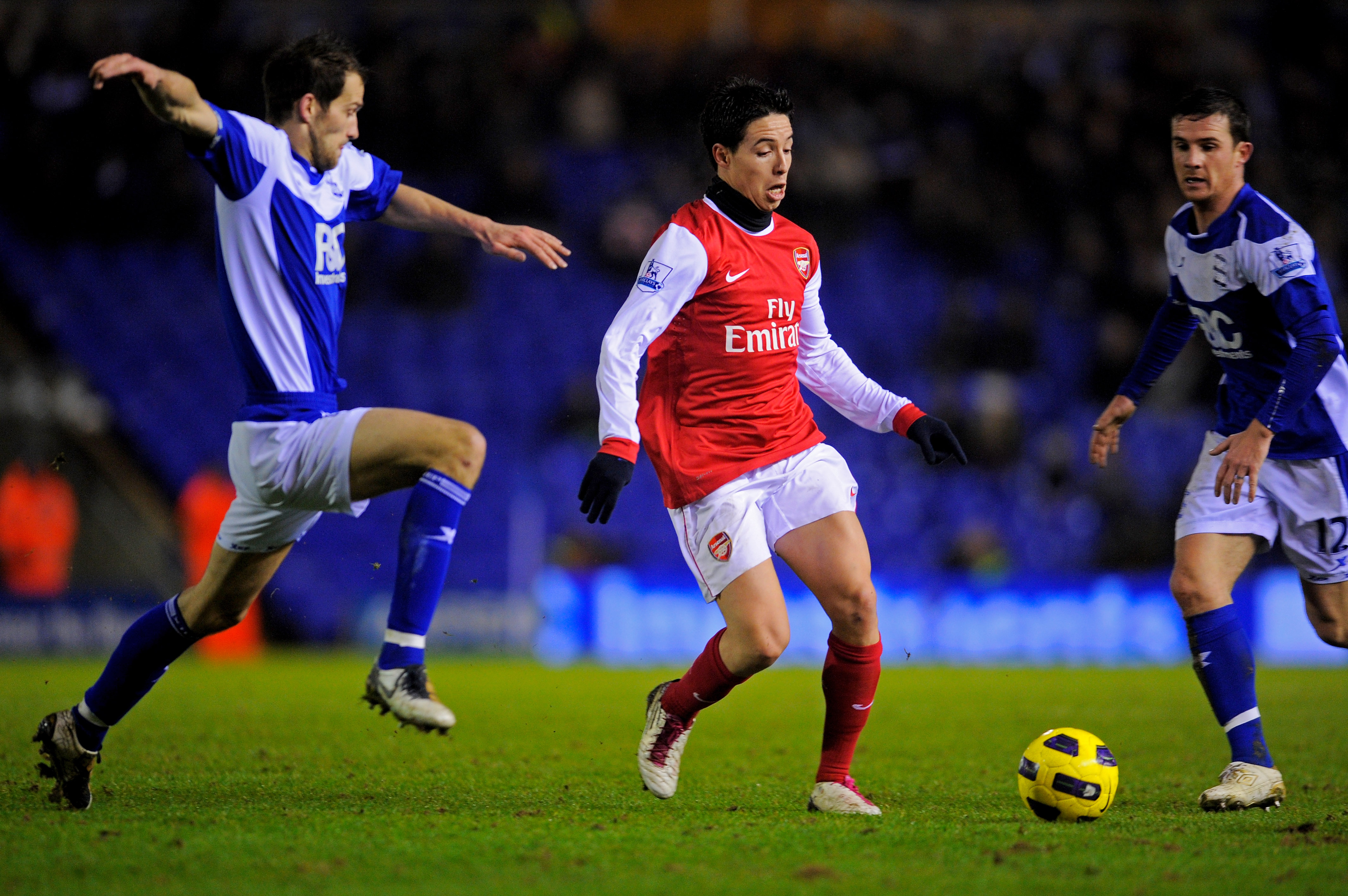 BIRMINGHAM, ENGLAND - JANUARY 01:  Samir Nasri of Arsenal is challenged by Roger Johnson of Birmingham during the Barclays Premier Leaue match between Birmingham City and Arsenal at St. Andrews on January 1, 2011 in Birmingham, England.  (Photo by Michael