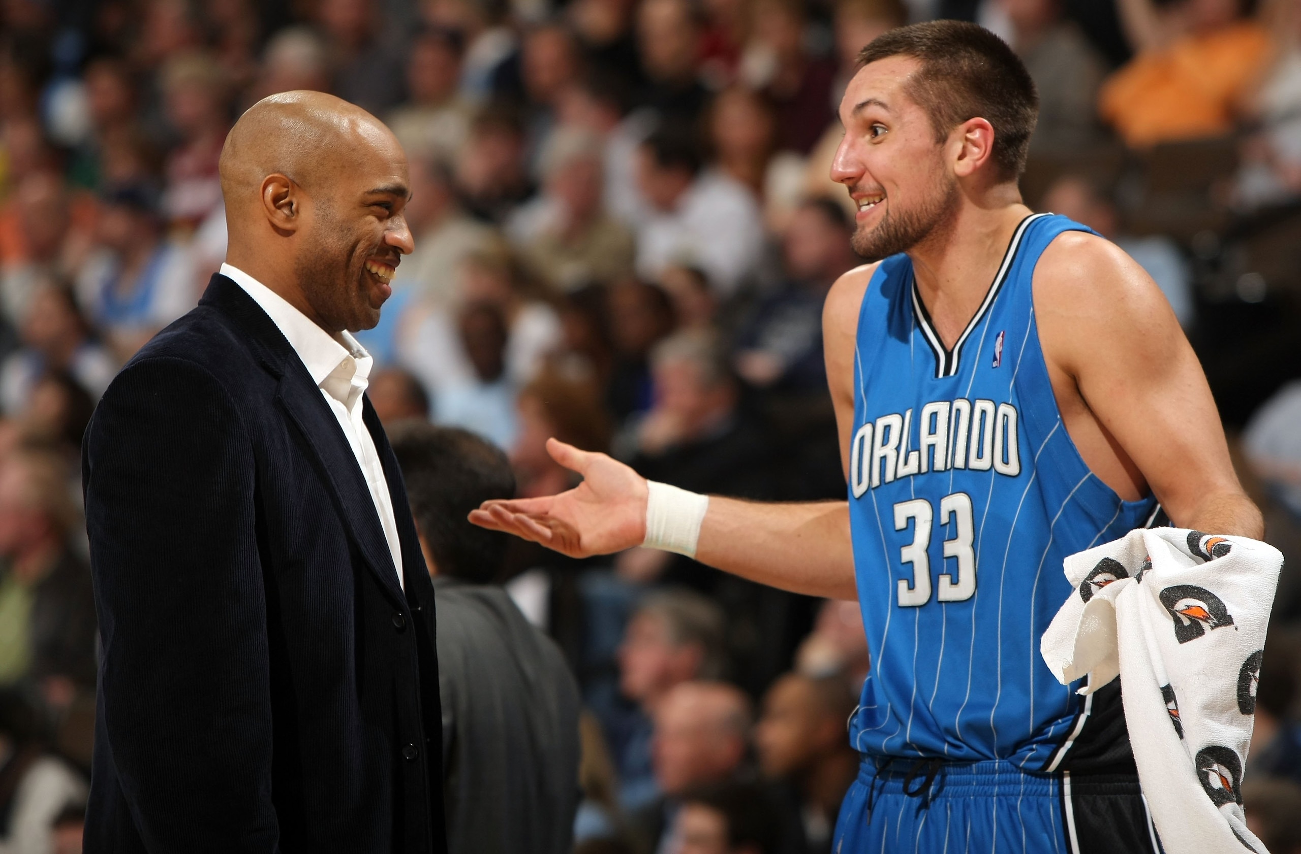 DENVER - JANUARY 13: Ryan Anderson #33 of the Orlando Magic talks with an injured Vince Carter during a time out against the Denver Nuggets during NBA action at Pepsi Center on January 13, 2010 in Denver, Colorado. The Nuggets defeated the Magic 115-97. DENVER - JANUARY 13: Ryan Anderson #33 of the Orlando Magic talks with an injured Vince Carter during a time out against the Denver Nuggets during NBA action at Pepsi Center on January 13, 2010 in Denver, Colorado. The Nuggets defeated the Magic 115-97.