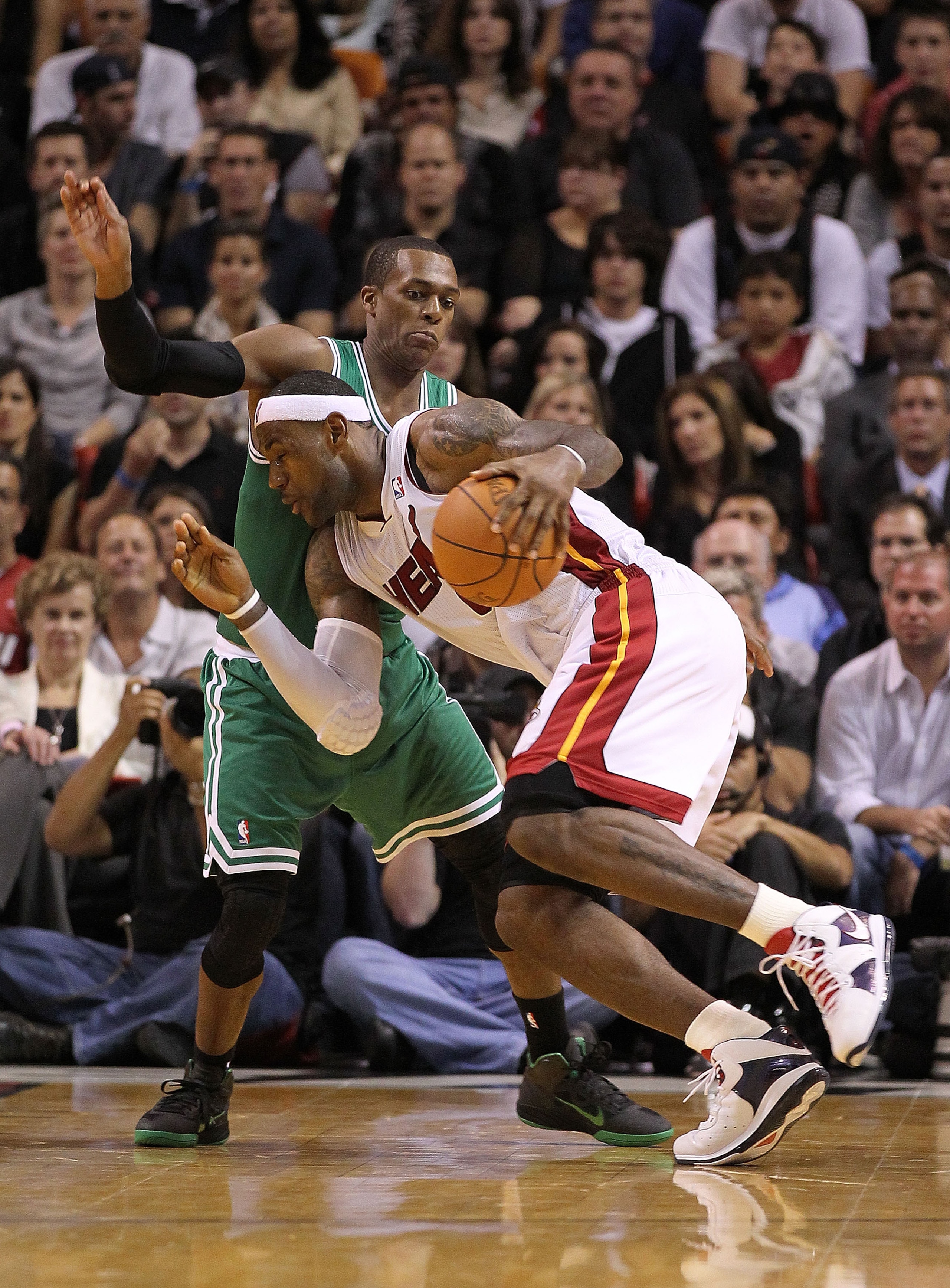 MIAMI - NOVEMBER 11:  LeBron James #6 of the Miami Heat drives against Rajon Rondo #9 during a game against the Boston Celtics at American Airlines Arena on November 11, 2010 in Miami, Florida. NOTE TO USER: User expressly acknowledges and agrees that, by