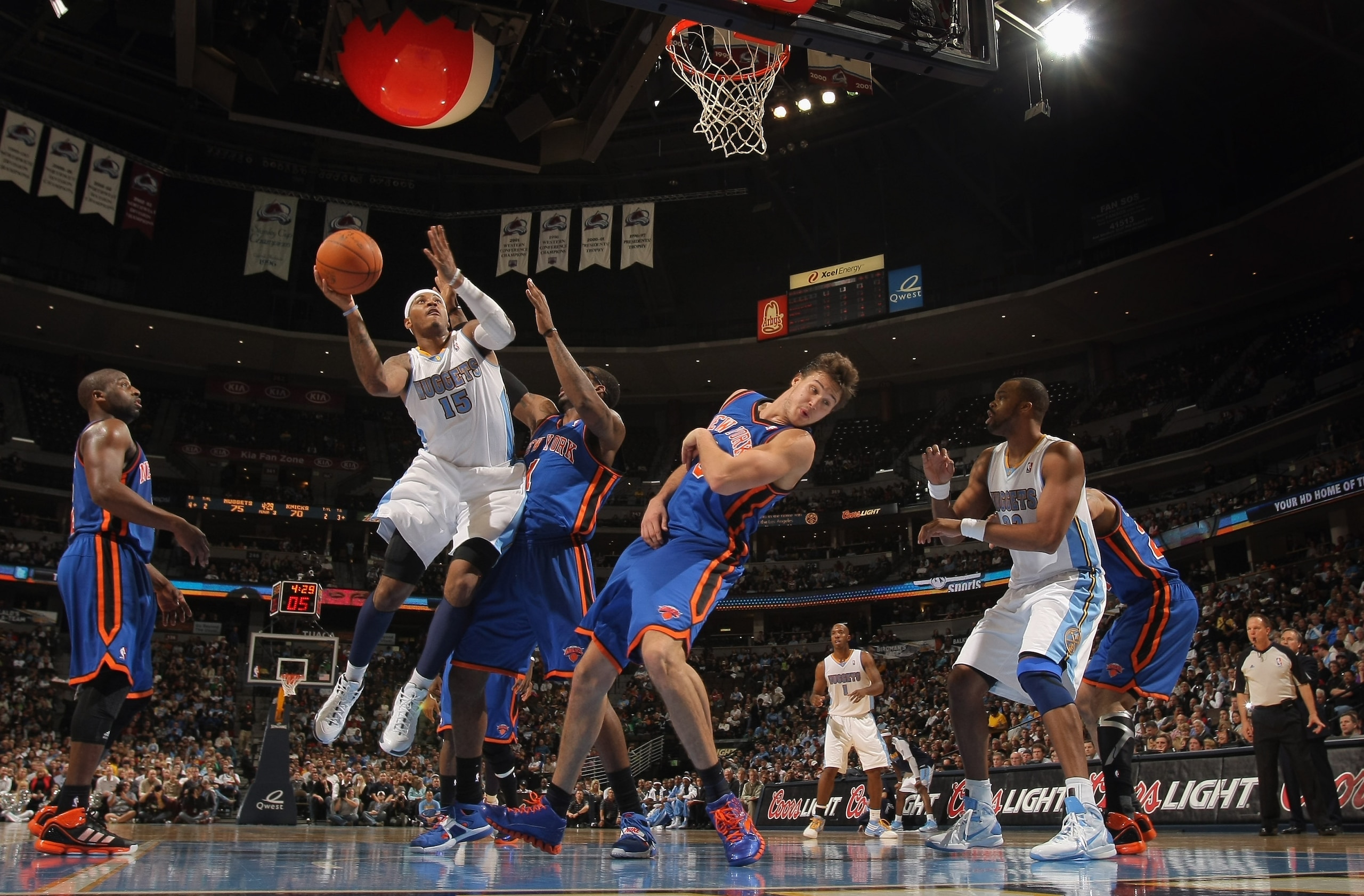 DENVER - NOVEMBER 16:  Carmelo Anthony #15 of the Denver Nuggets puts up a shot over Amar'e Stoudemire #1 and Danilo Gallinari #8 of the New York Knicks at the Pepsi Center on November 16, 2010 in Denver, Colorado. The Nuggets defeated the Knicks 120-118.