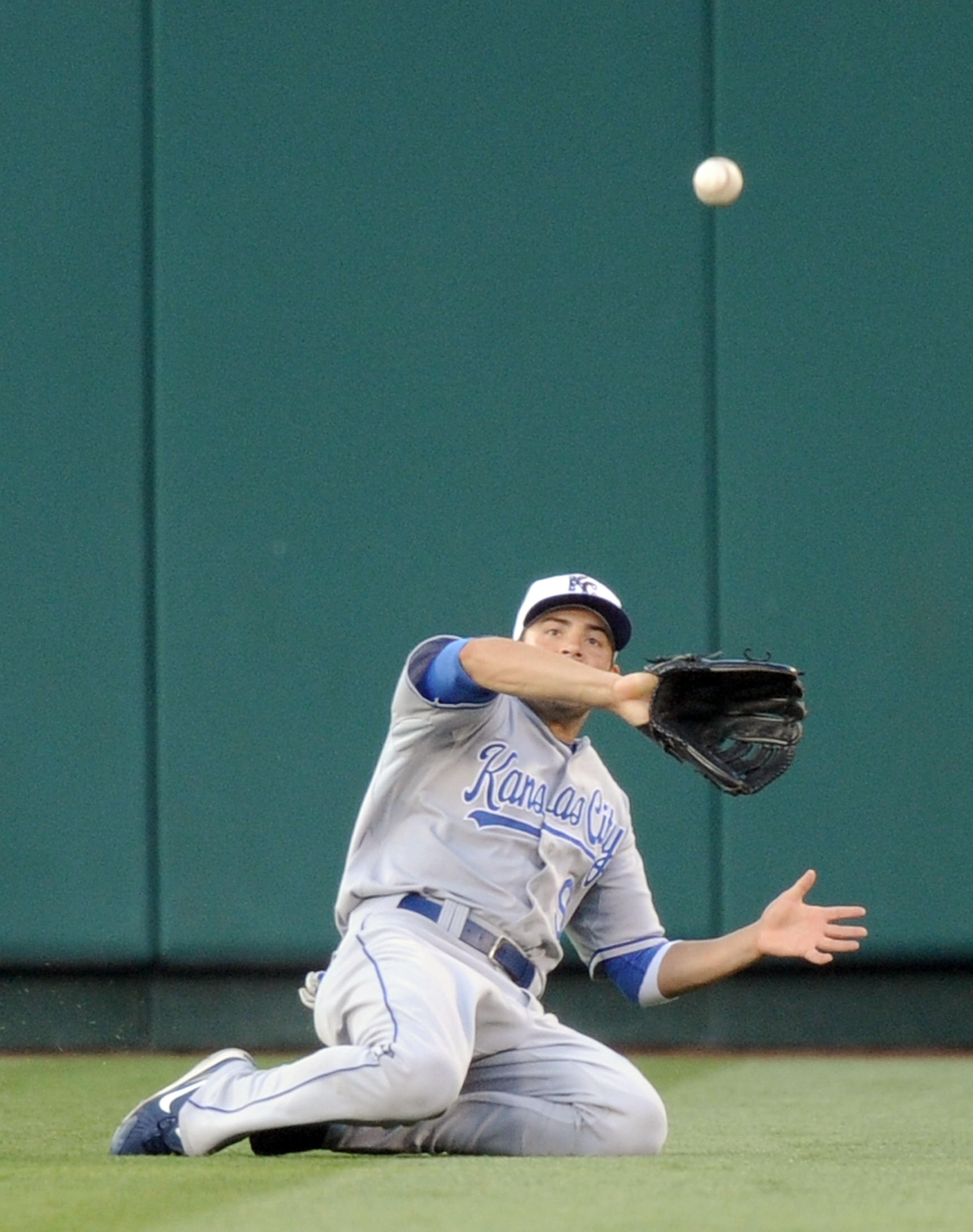 ANAHEIM, CA - JULY 02:  David DeJesus #9 of the Kansas City Royals slides as he makes a catch for an out of Torii Hunter #48 of the Los Angeles Angels during the first inning at Angel Stadium on July 2, 2010 in Anaheim, California.  (Photo by Harry How/Ge